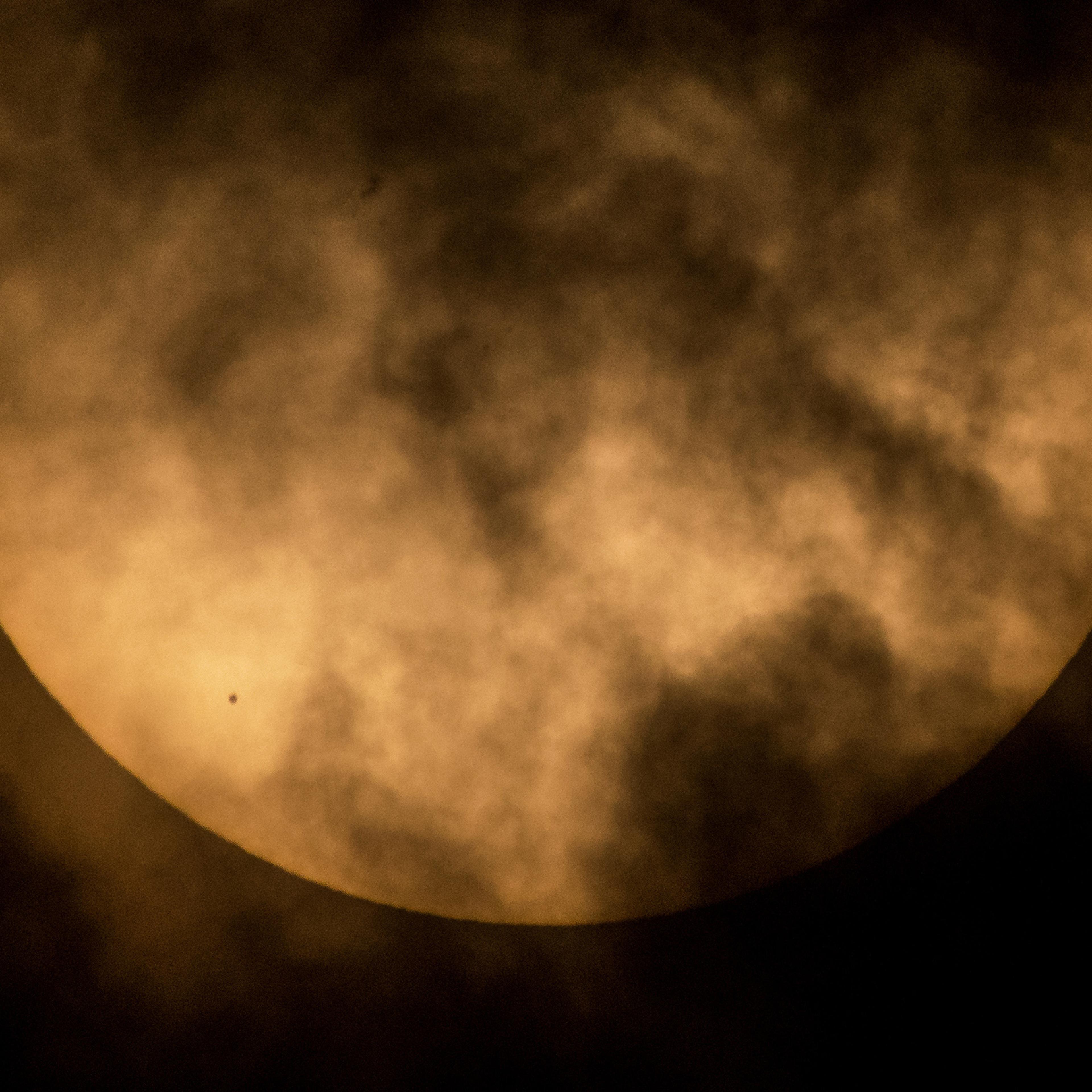 The planet Mercury is seen in silhouette, lower left, as it transits across the face of the sun in this photo taken from NASA Headquarters in Washington, DC., May 9, 2016.