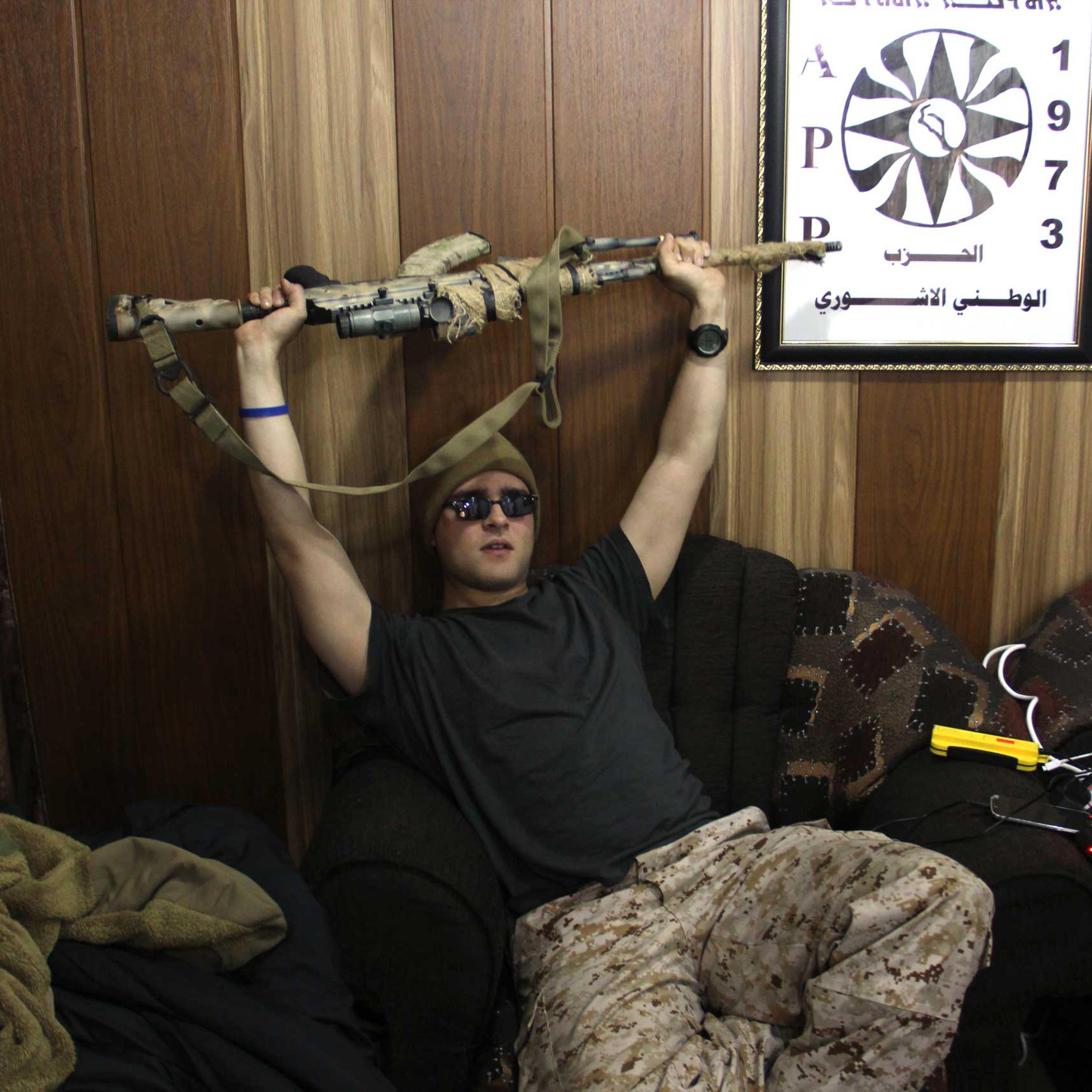 Louis in the living room where the foreign recruits sleep in Dwekh Nawsha headquarters in Dohuk, northern Iraq.