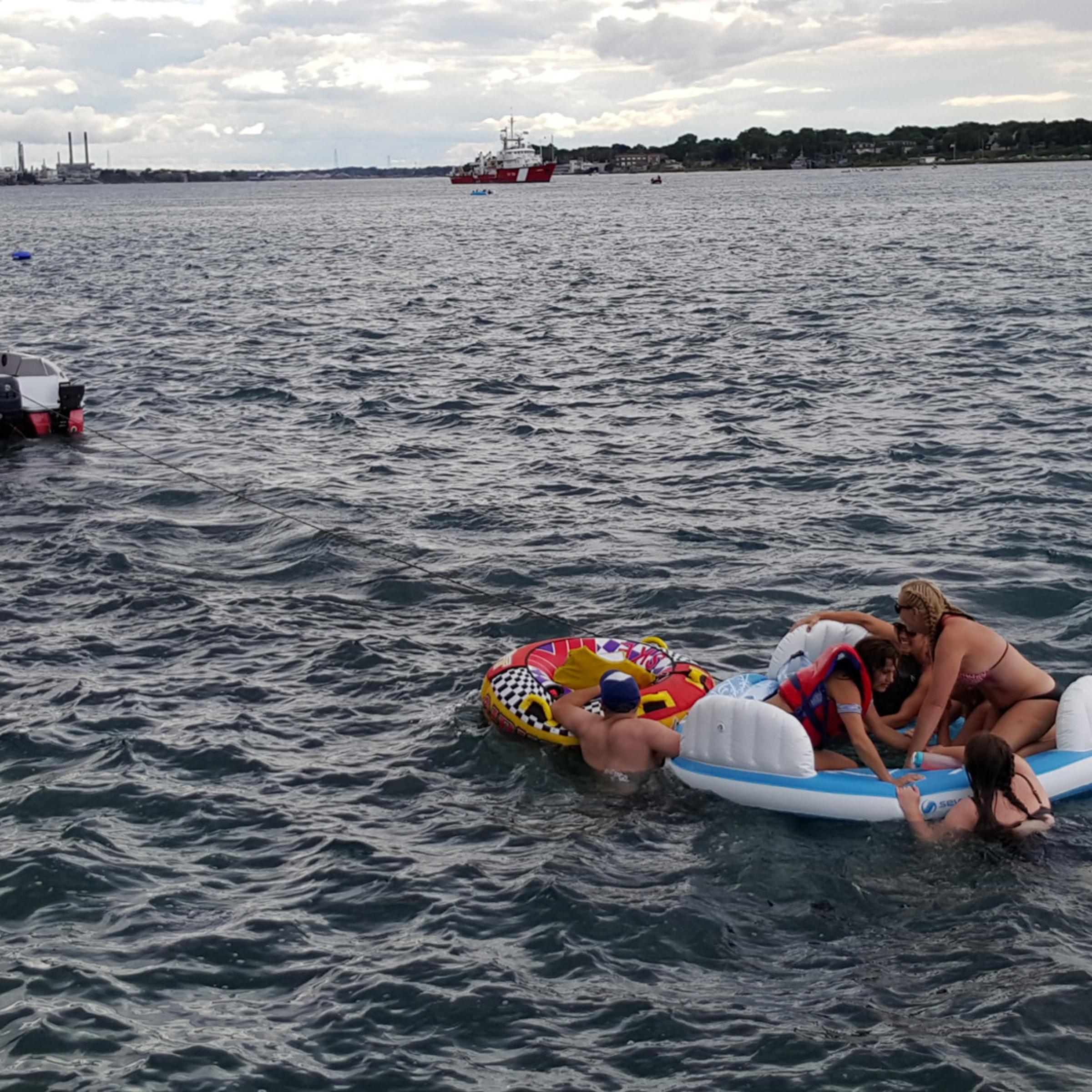 A Canadian Coast Guard ship tows floatation devices used by U.S. partiers to the Canadian side of the St. Clair River between Michigan and Ontario on August 21, 2016. About 1,500 Americans ended up in Canada after getting hit by strong wind and rain. Can