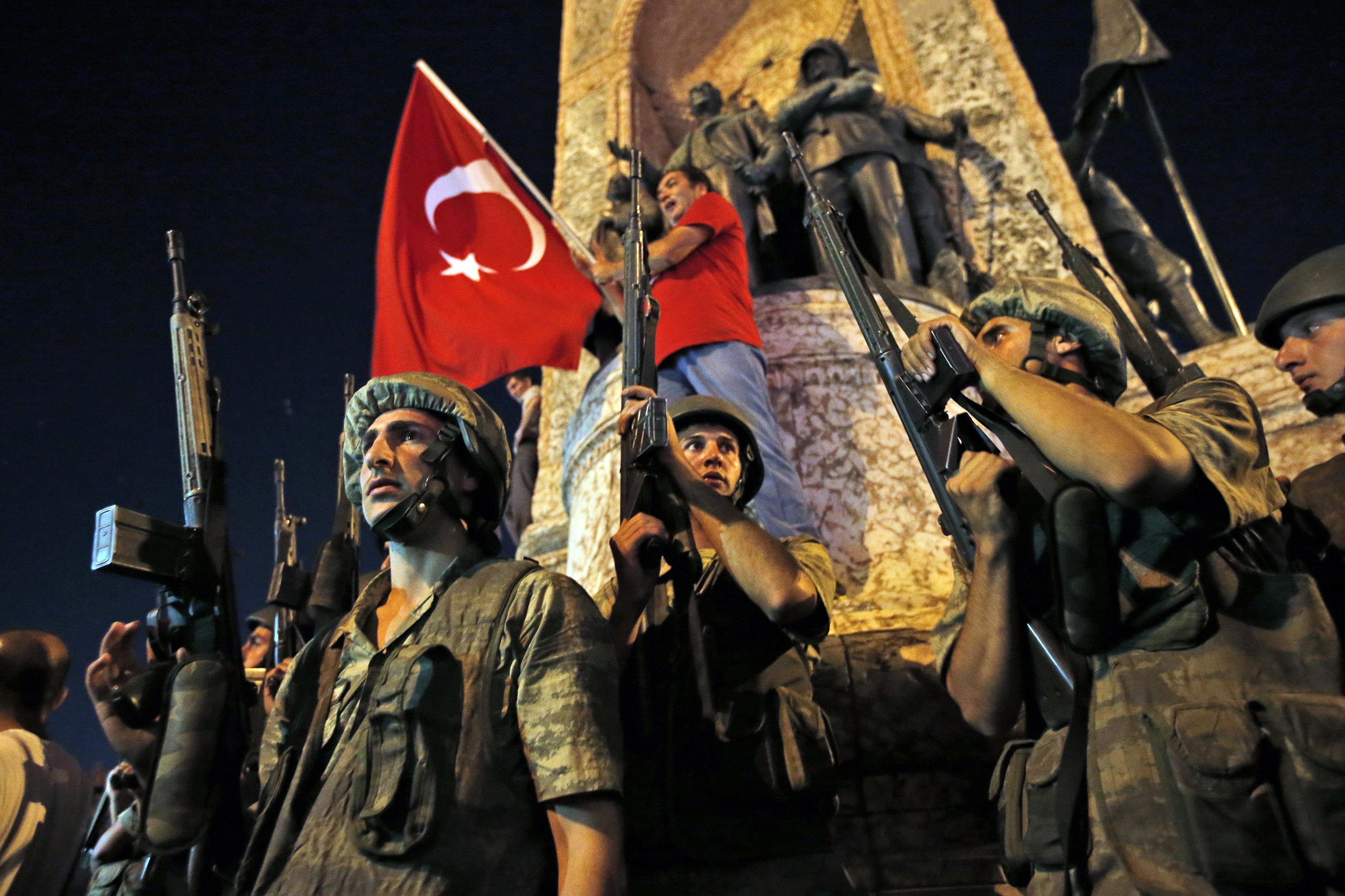 Turkish soldiers secure the area as supporters of President Recep Tayyip Erdogan protest in Istanbul's Taksim Square early on July 16, 2016.