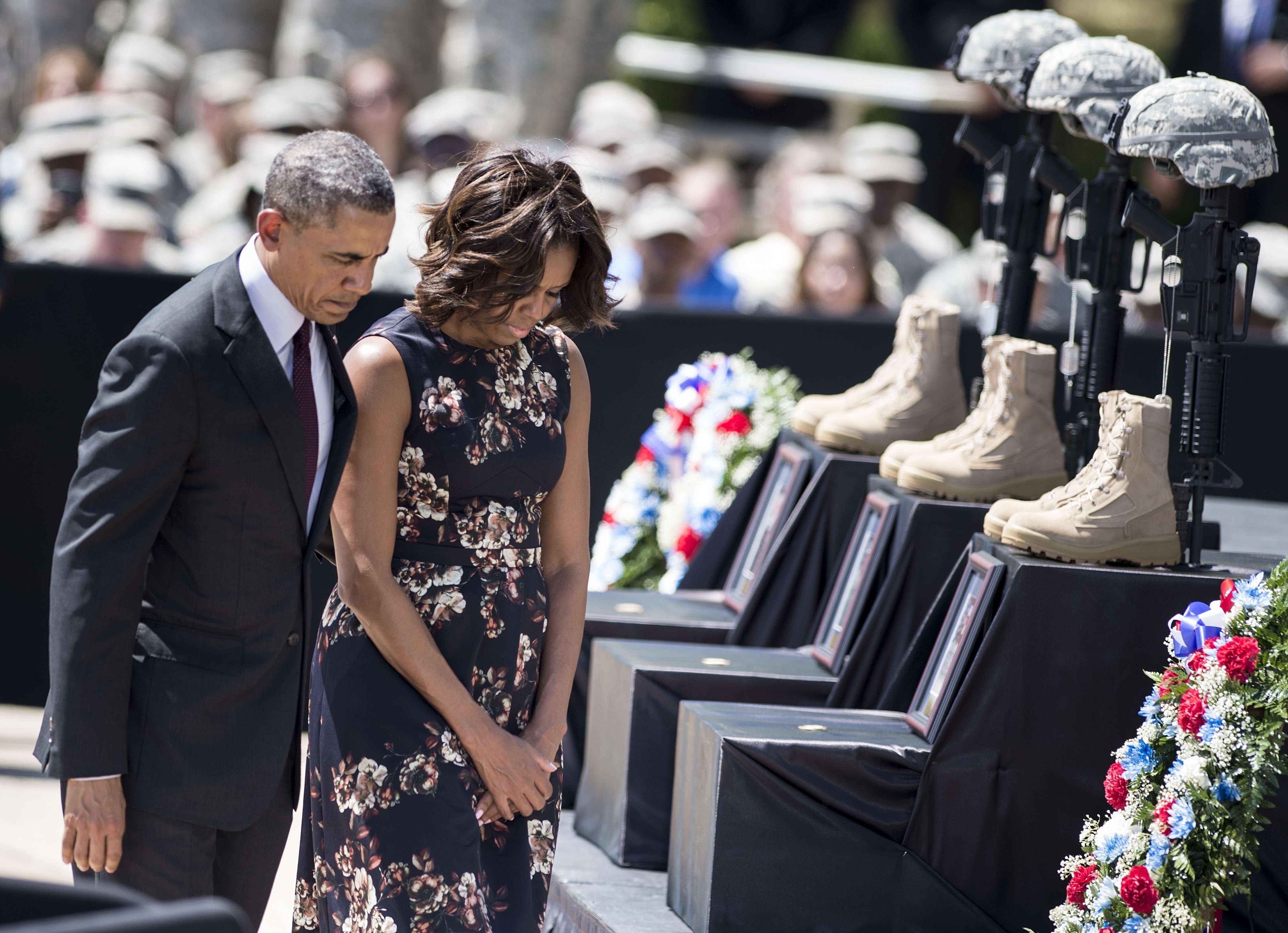 President Barack Obama and First Lady Michelle Obama pay their respects during a memorial service at Fort Hood April 9, 2014 in Texas.