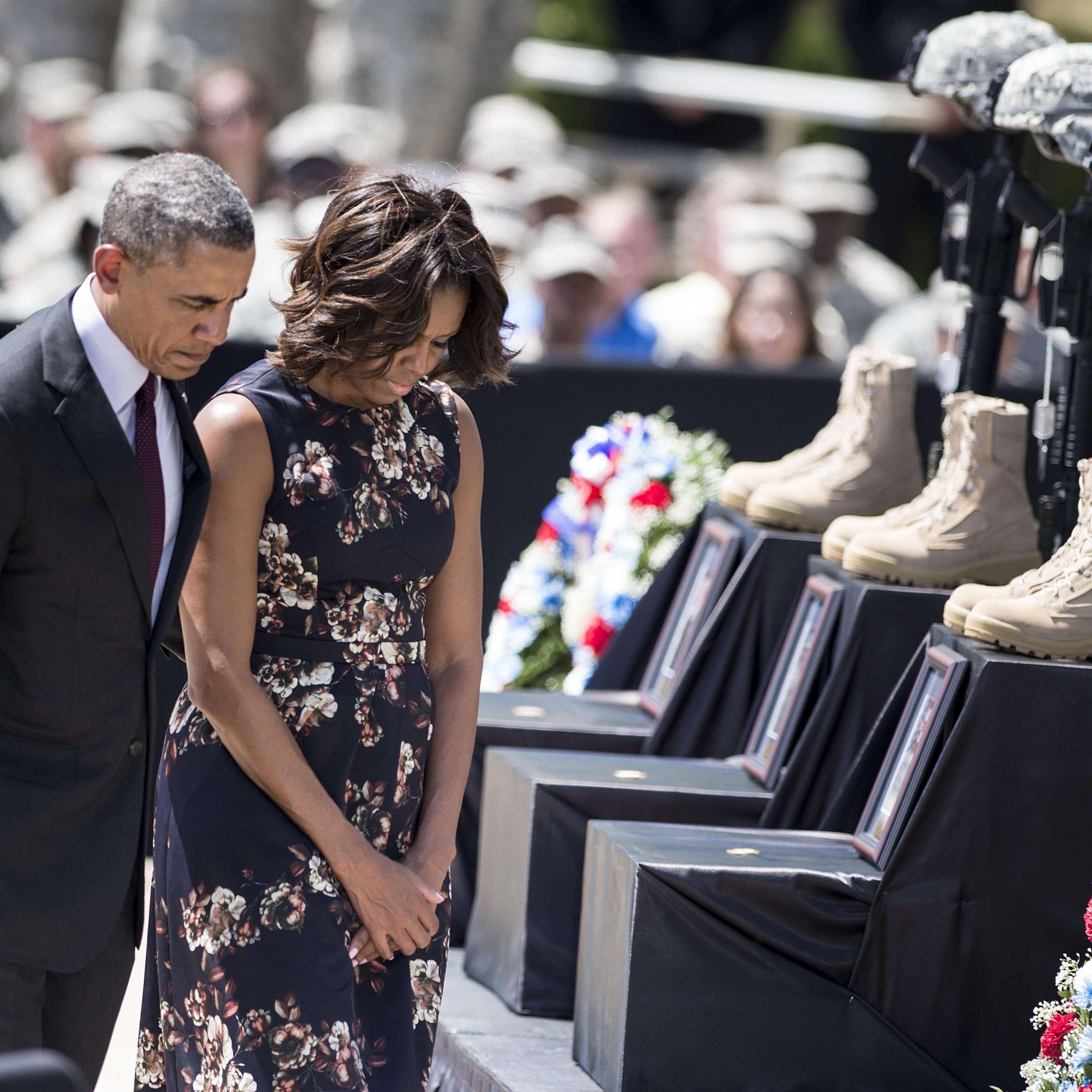 President Barack Obama and First Lady Michelle Obama pay their respects during a memorial service at Fort Hood April 9, 2014 in Texas.