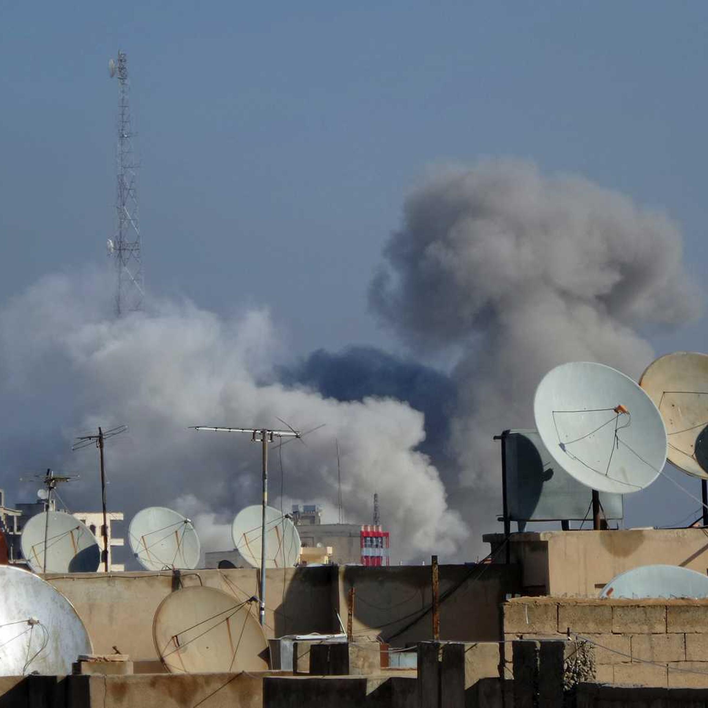 Smoke rises after what activists said were four air strikes by forces loyal to Syria's president Bashar Al-Assad in Raqqa November 28, 2014.