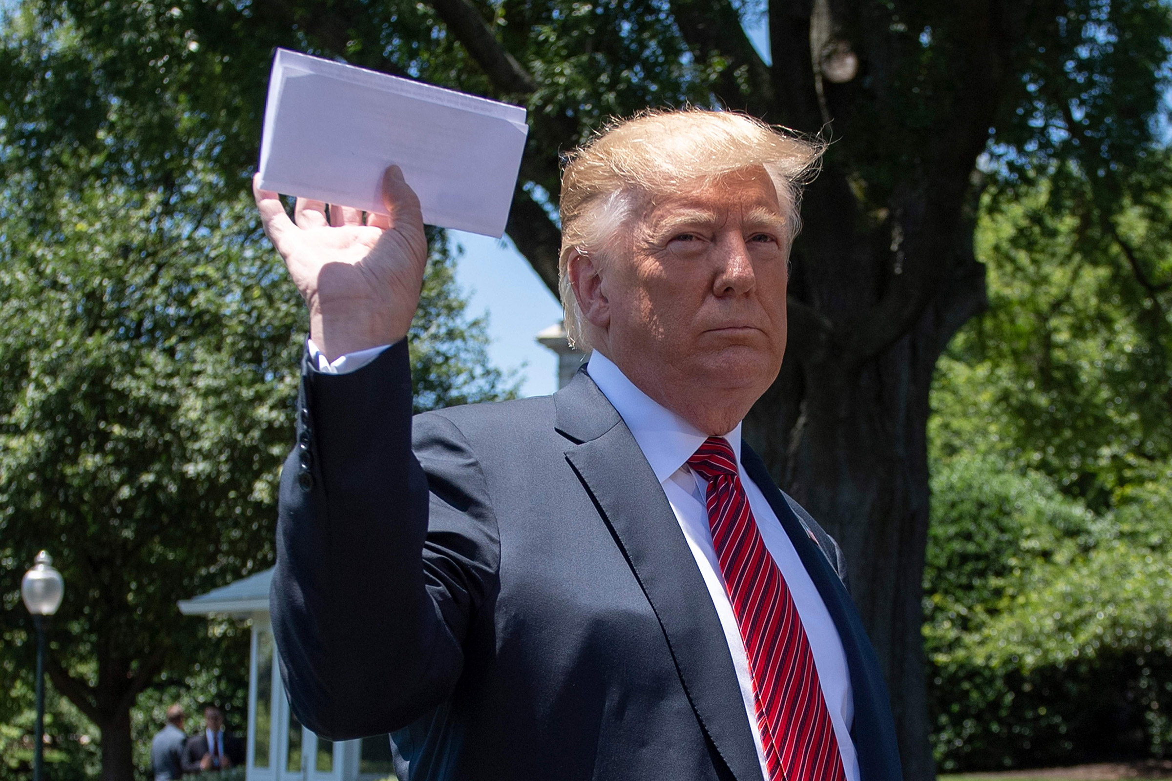 At the White House on June 11, President Trump holds what he said was a page of a new migration deal with Mexico.