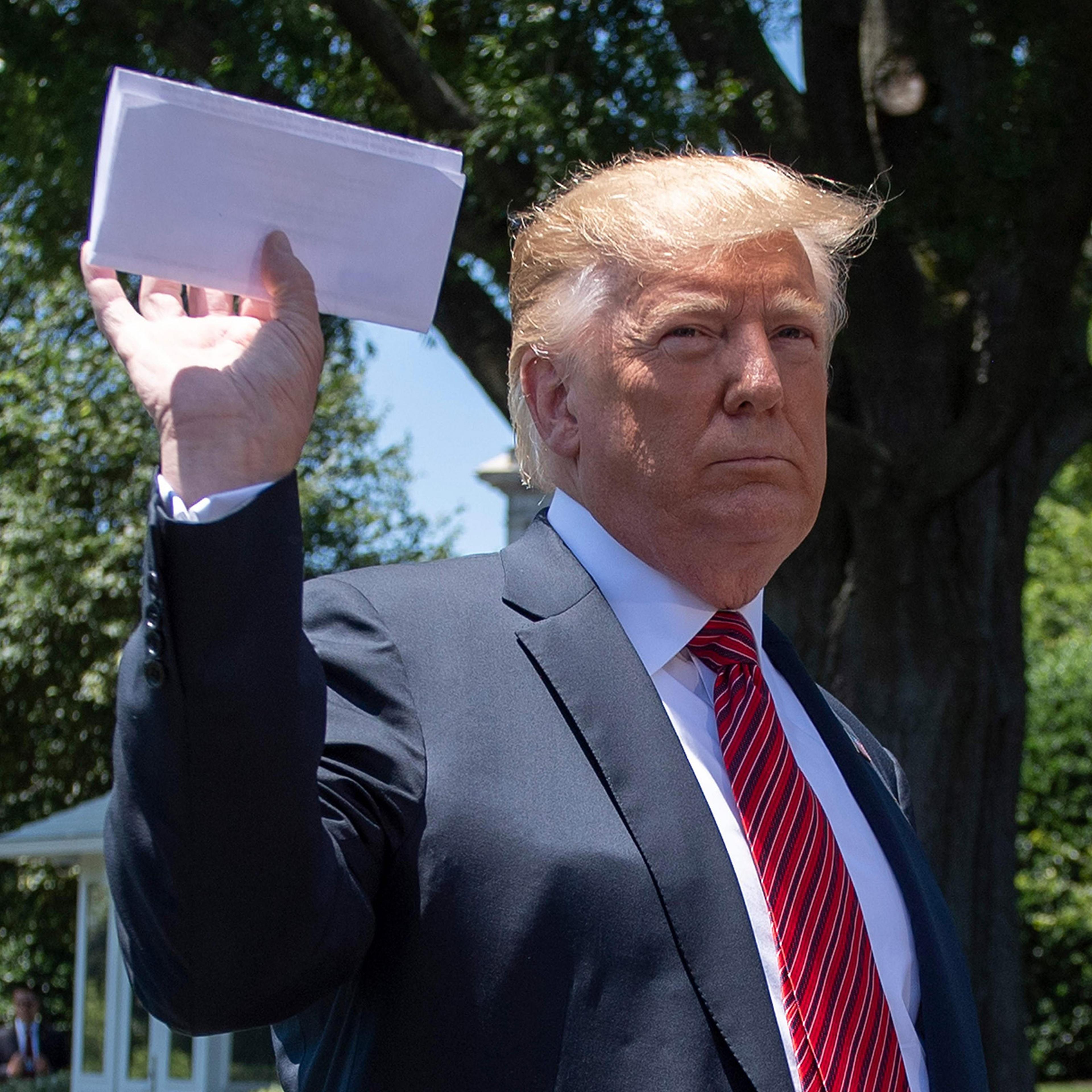 At the White House on June 11, President Trump holds what he said was a page of a new migration deal with Mexico.