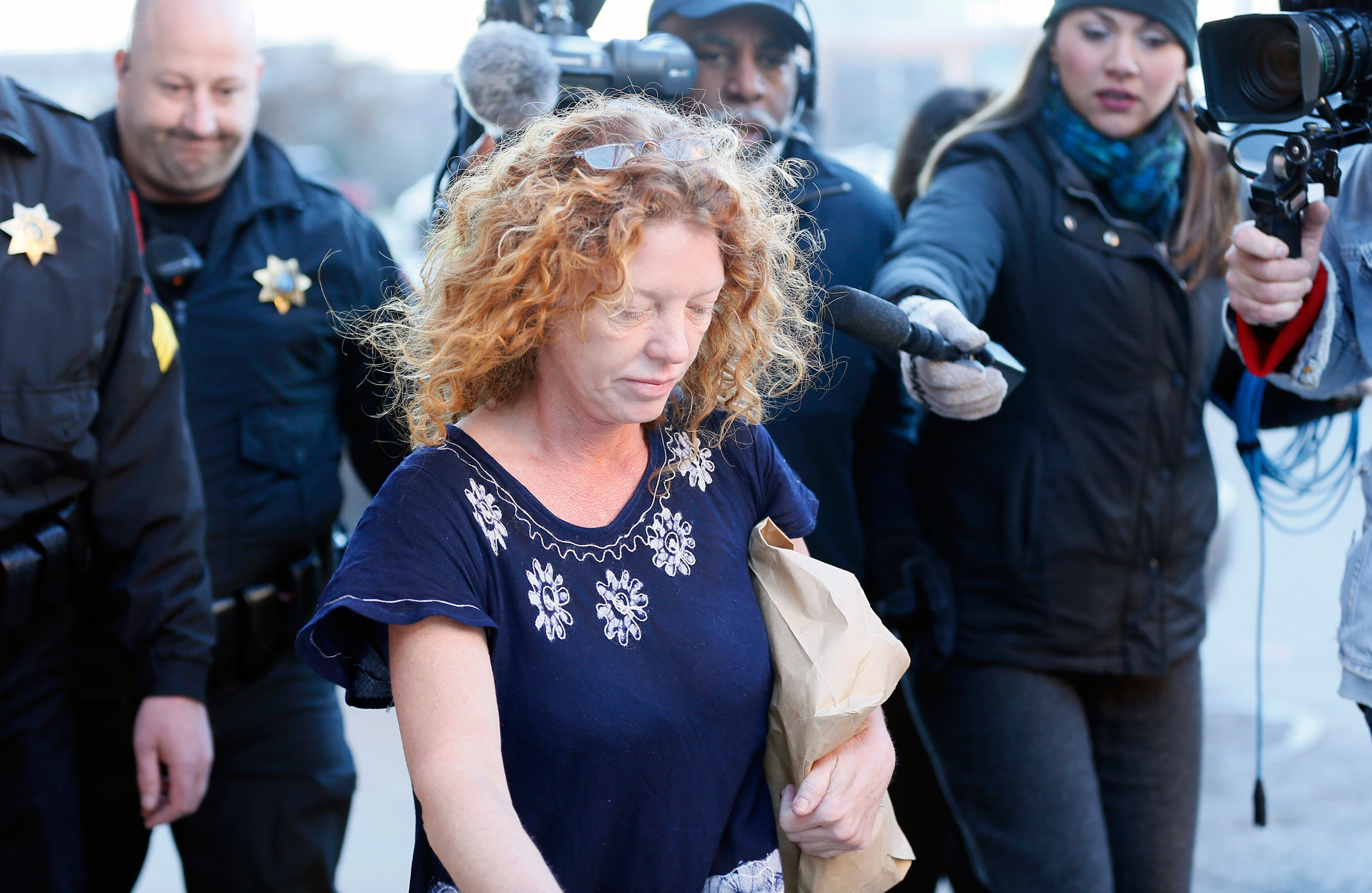 Tonya Couch, center, the mother of a Texas teen who used an "affluenza" defense in a drunken wreck, leaves Tarrant County Jail, Tuesday, Jan. 12, 2016, in Fort Worth, Texas. She is to be fitted with a GPS monitor before release. A judge decreased Couch's
