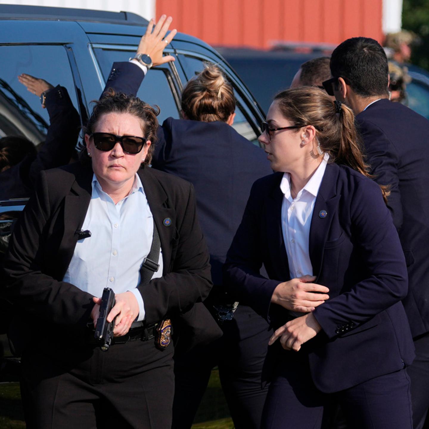 U.S. Secret Service agents surround the vehicle carrying Republican presidential candidate former President Donald Trump at a campaign rally in in Butler, Pa., on July 13, 2024.