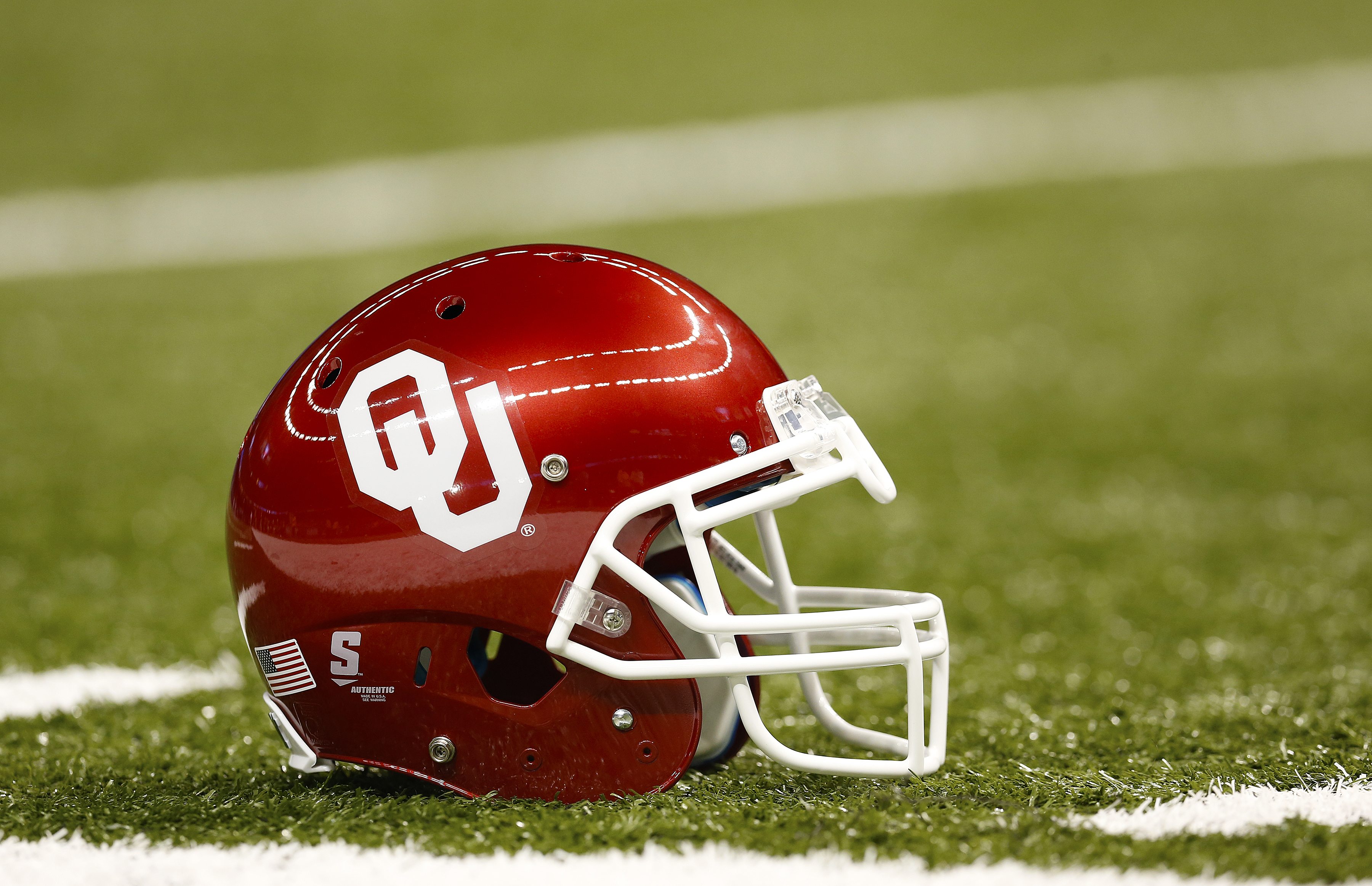 University of Oklahoma Sooners helmet is seen on the field a game against the University of Alabama Crimson Tide in New Orleans on Jan. 2, 2014.