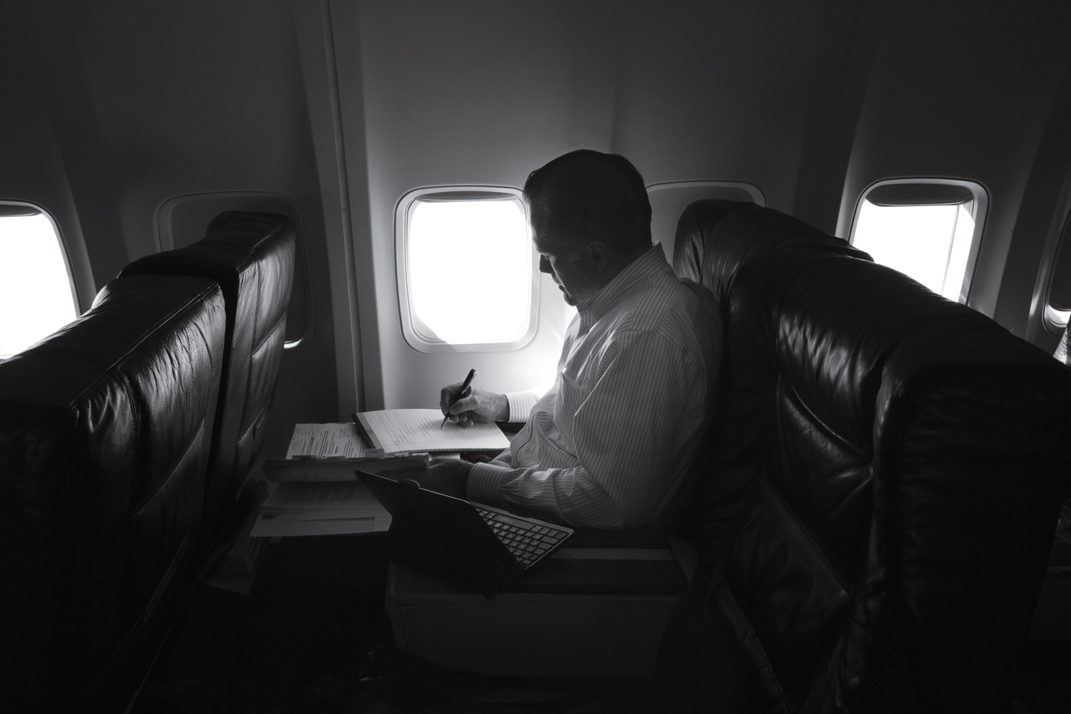 Aug. 20, 2012. Mitt Romney, in a quiet moment, works on the plane heading towards events in New Orleans, La. 