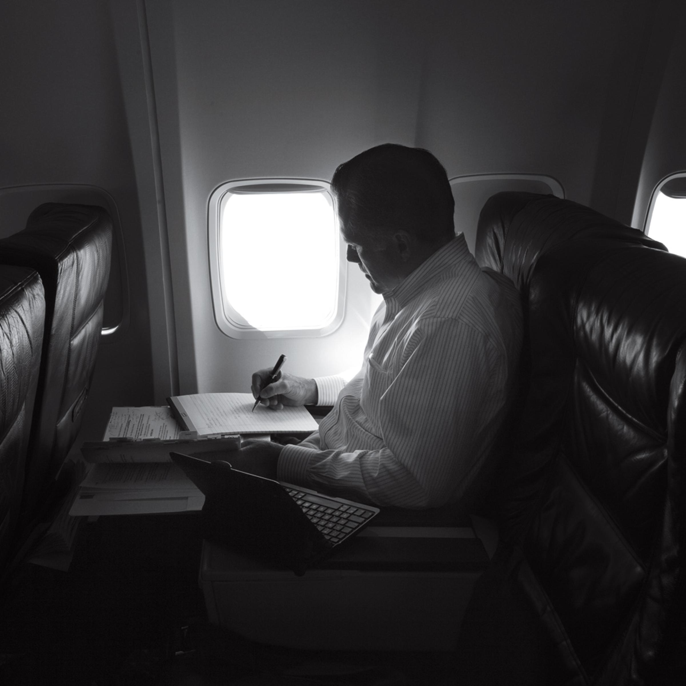 Aug. 20, 2012. Mitt Romney, in a quiet moment, works on the plane heading towards events in New Orleans, La.