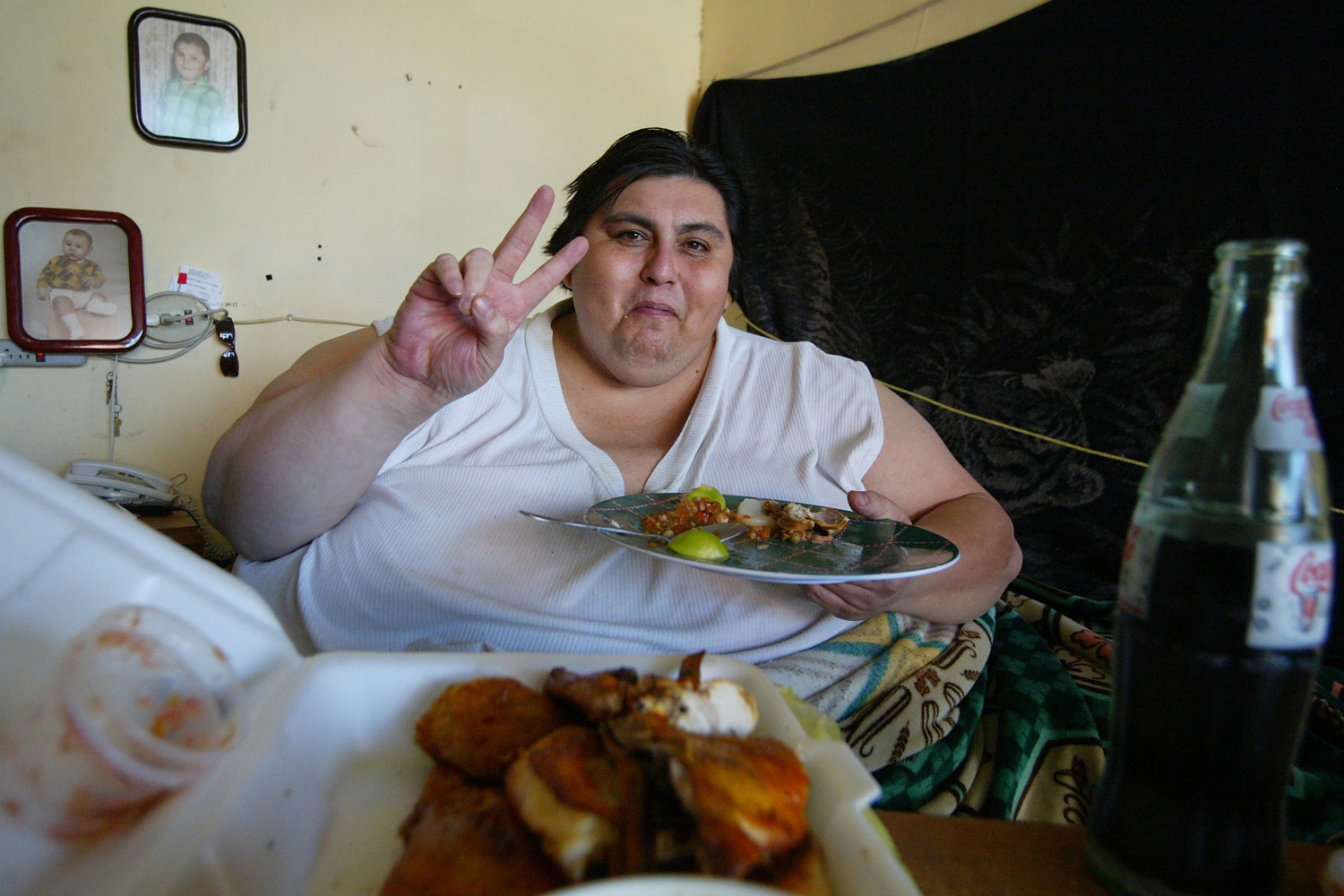 Manuel Uribe eats in his bed at home in Monterrey, Mexico, January 19, 2006.