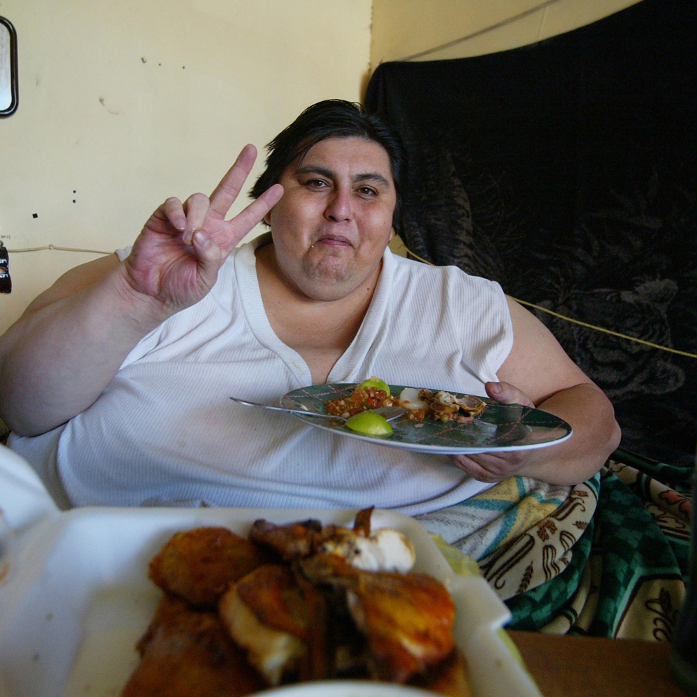 Manuel Uribe eats in his bed at home in Monterrey, Mexico, January 19, 2006.