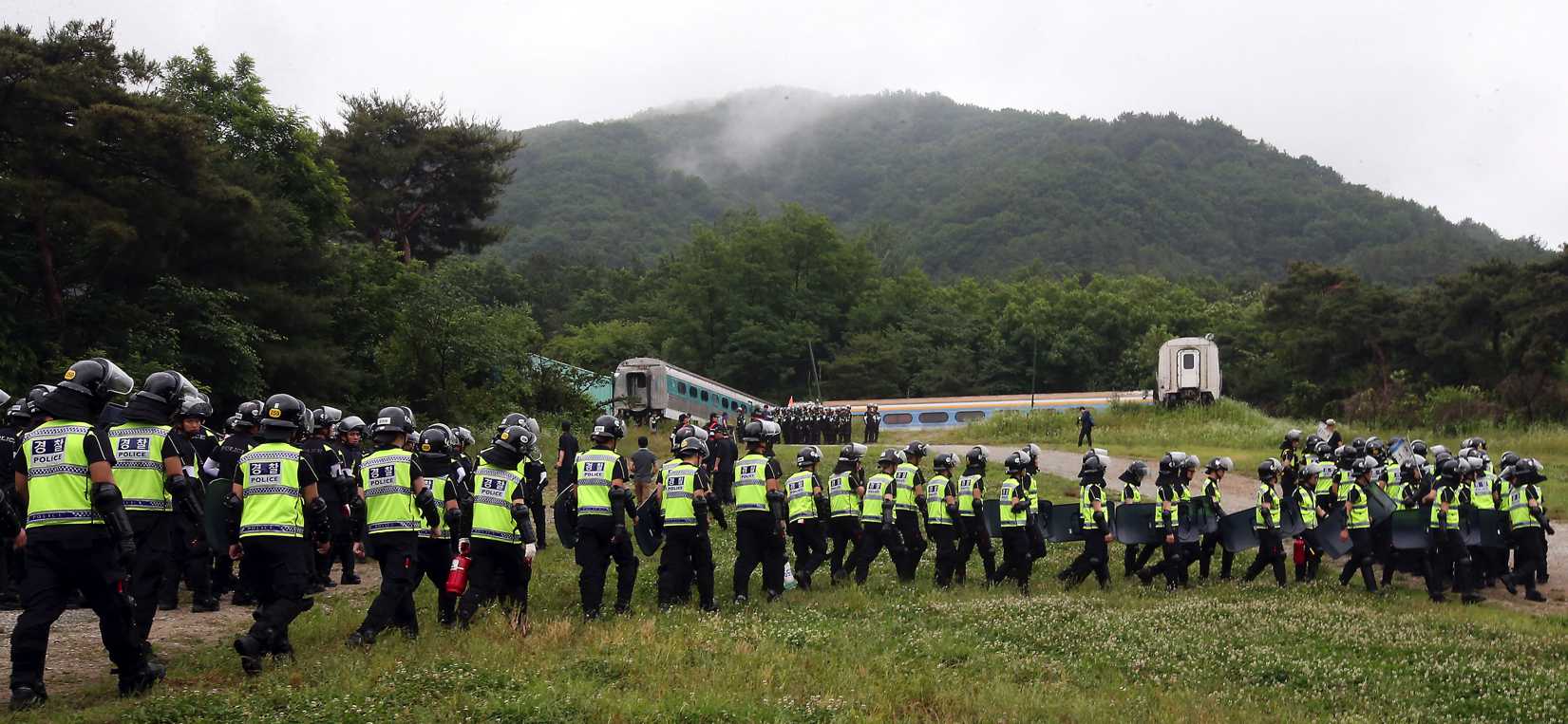 Police officers raid a religious facility owned by the Evangelical Baptist Church in Anseong, South Korea, on June 11, 2014