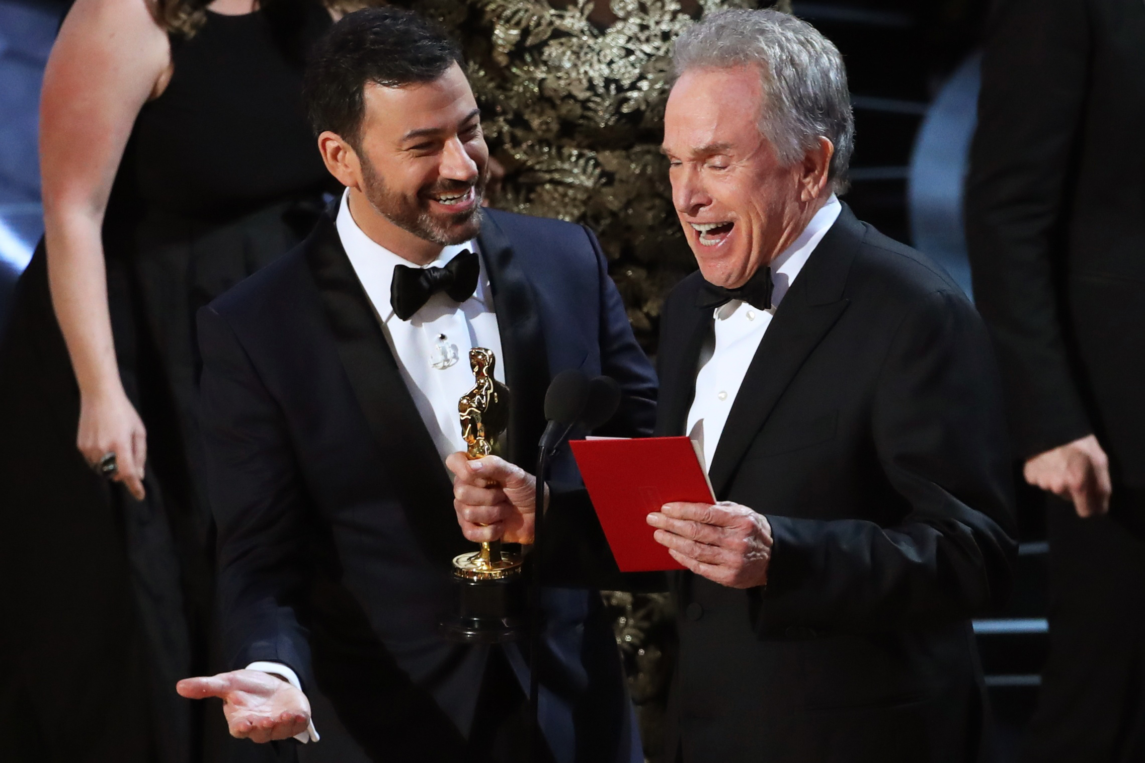 Jimmy Kimmel and Warren Beatty laugh after correcting the Best Picture Oscar from La La Land to Moonlight.