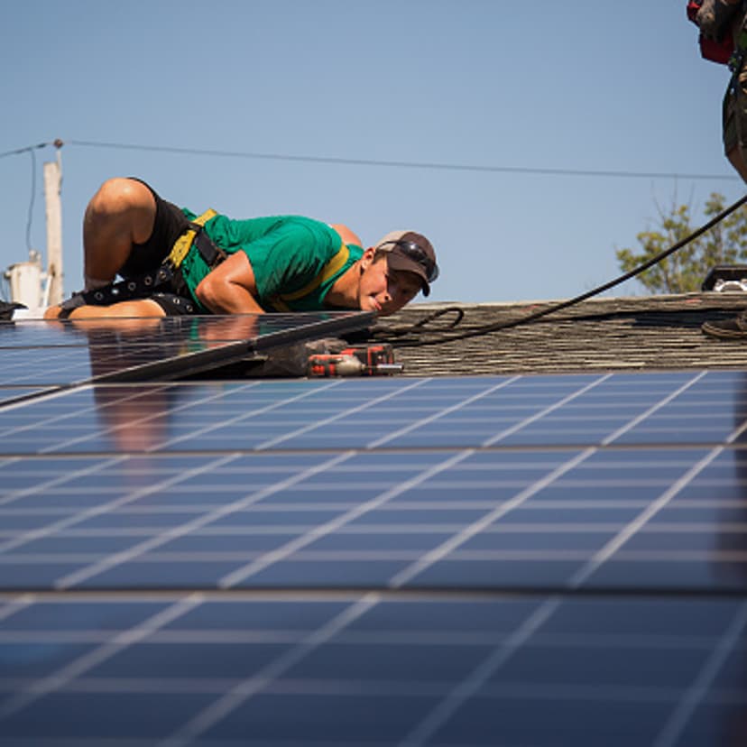 Dave Scarantino, senior installer for SolarCity Corp, installs solar panels on the rooftop of a home in Kendall Park, N.J., U.S., on Tuesday, July 28, 2014.