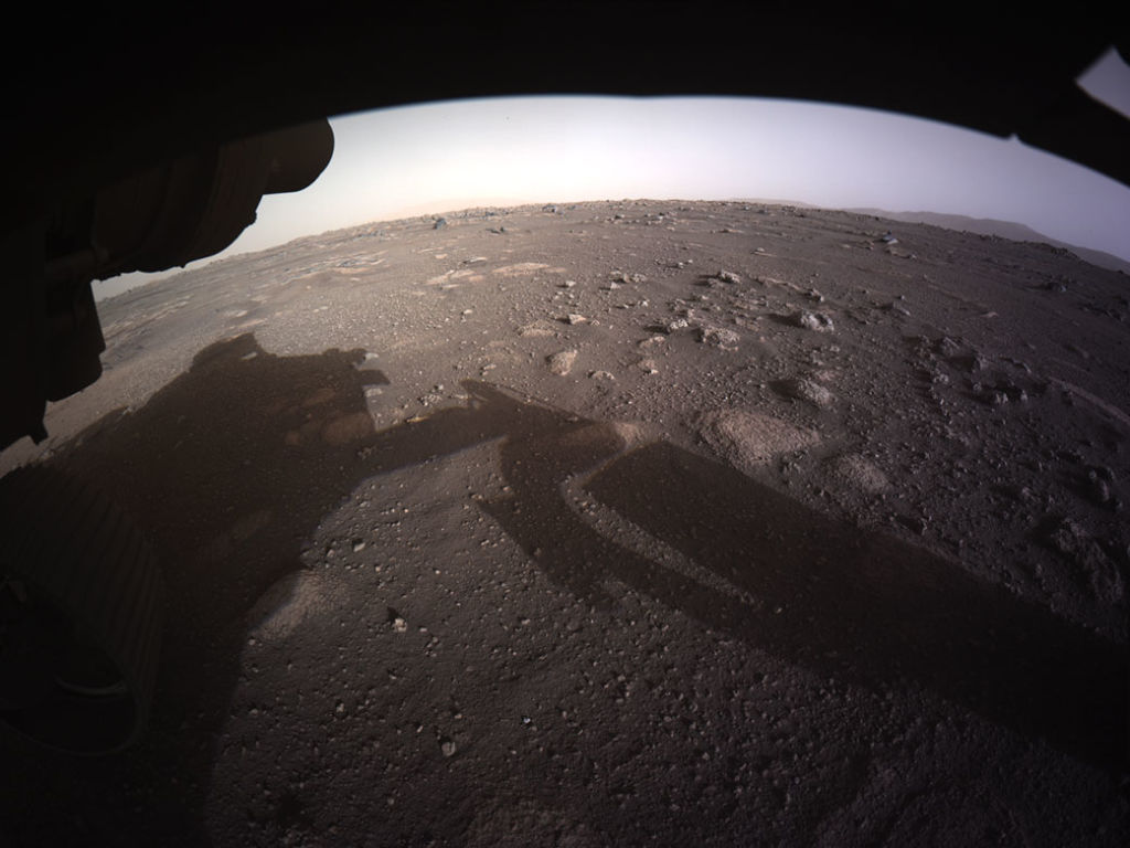 In this handout image provided by NASA, the first high-resolution, color image to be sent back by the Hazard Cameras (Hazcams) on the underside of NASA’s Perseverance Mars rover after its landing in the area known as Jezero crater on February 18, 2021 on