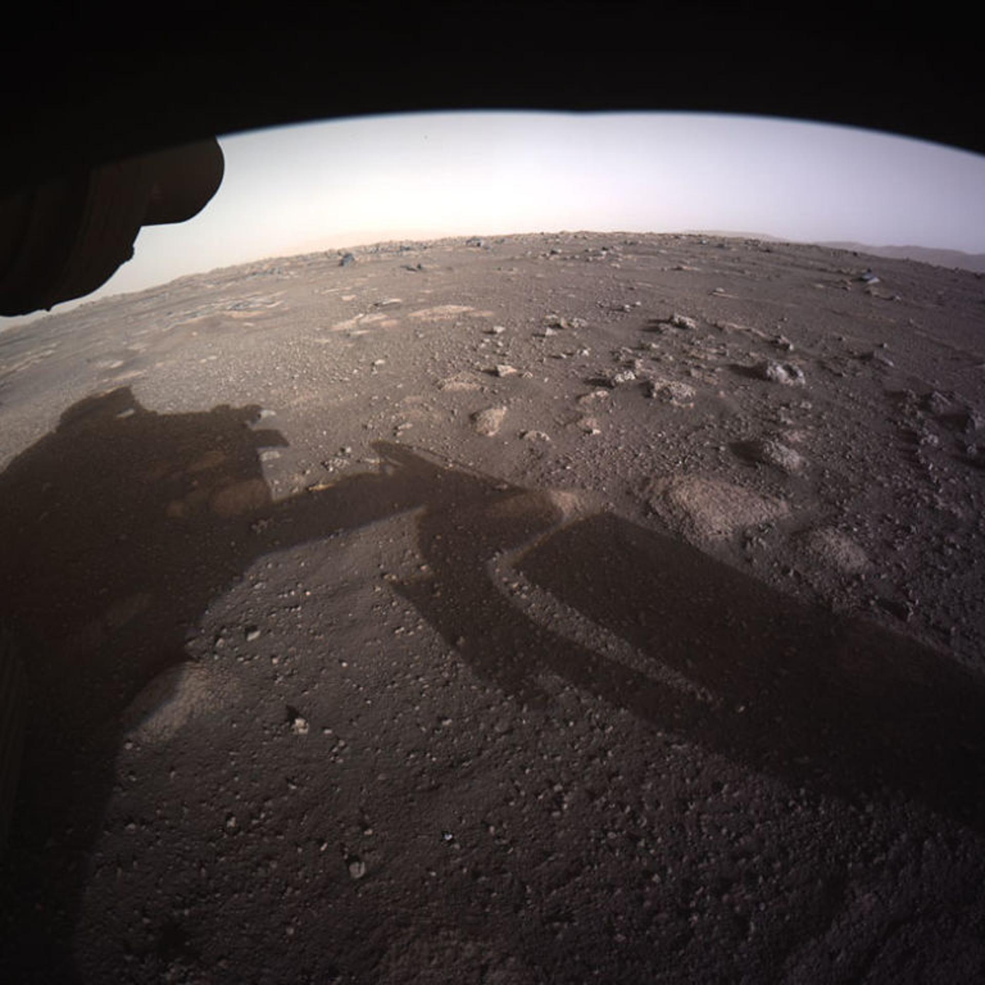 In this handout image provided by NASA, the first high-resolution, color image to be sent back by the Hazard Cameras (Hazcams) on the underside of NASA’s Perseverance Mars rover after its landing in the area known as Jezero crater on February 18, 2021 on