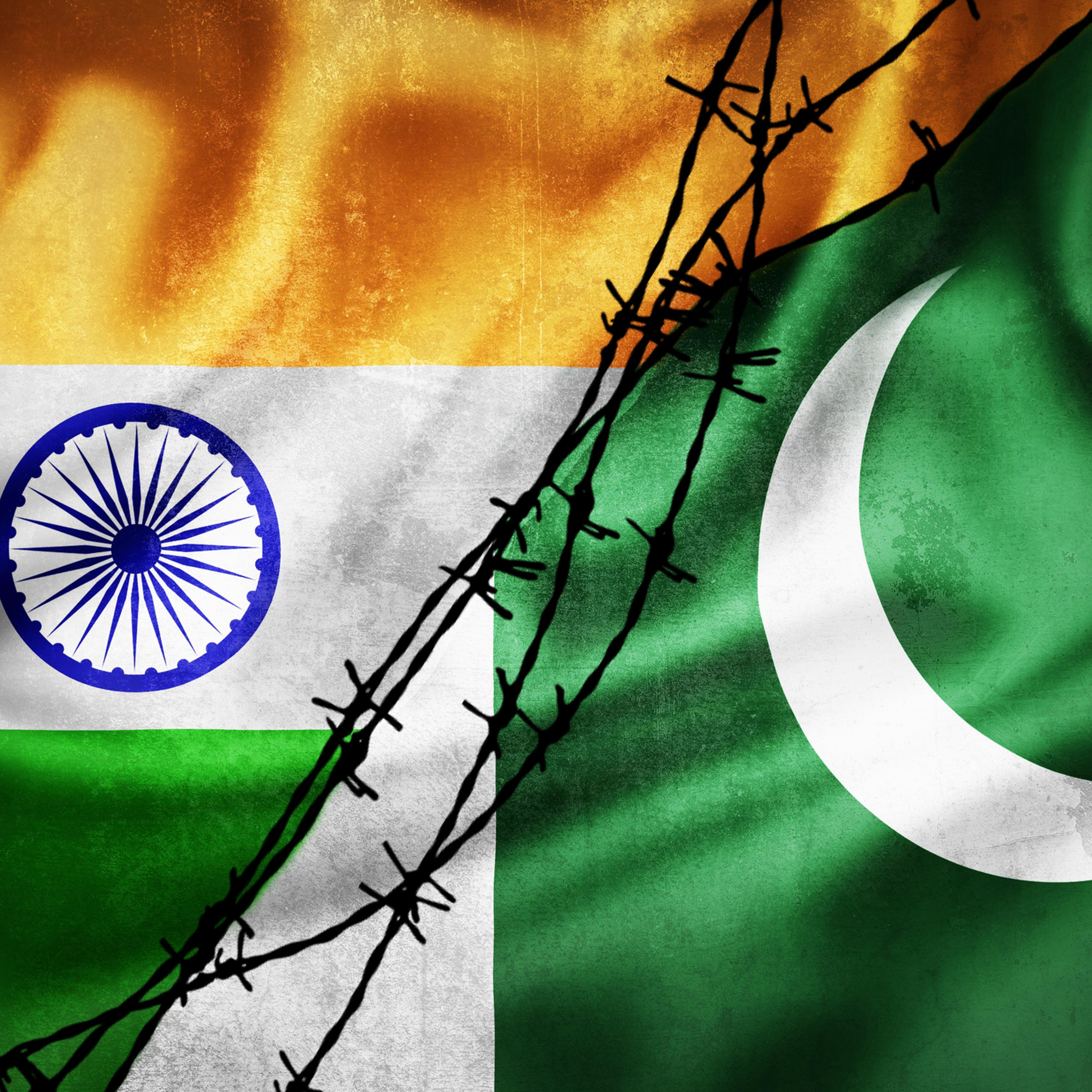 flags of India and Pakistan divided by barb wire illustration, concept of tense relations between India and Pakistan