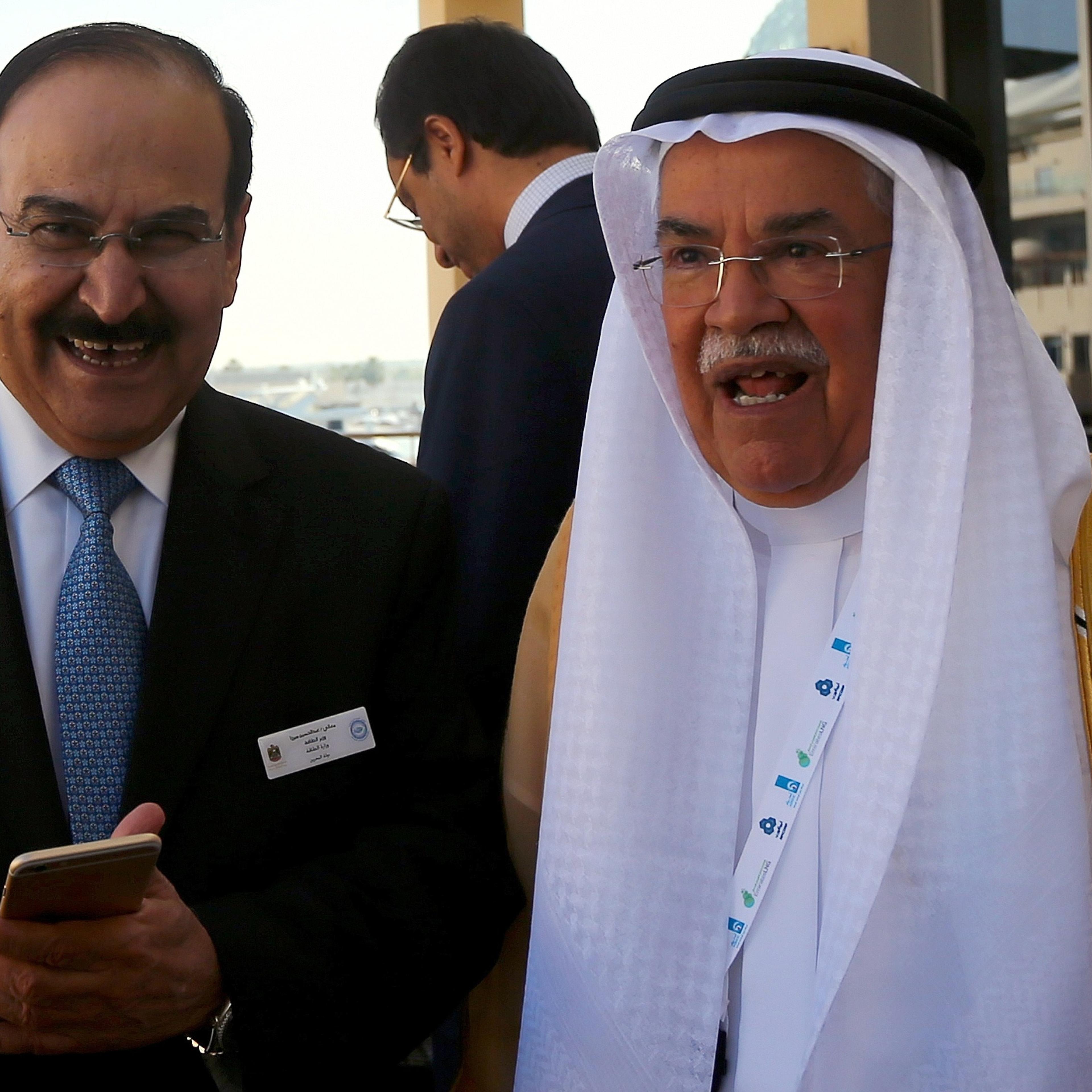 From left: Bahraini Oil Minister Abdulhussain bin Ali Mirza stands with Saudi Oil Minister Ali al-Naimi during the 10th Arab Energy Conference in Abu Dhabi, on Dec. 21, 2014.