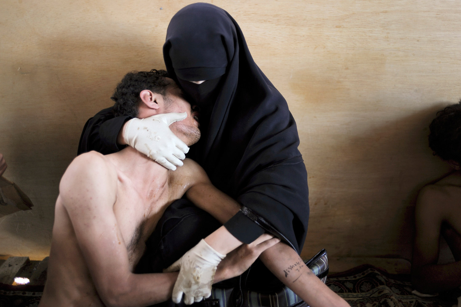World Press Photo of the Year 2011<br><br>A woman holds a wounded relative in her arms, inside a mosque used as a field hospital by demonstrators against the rule of President Ali Abdullah Saleh, during clashes in Sanaa, Yemen on October 15, 2011.