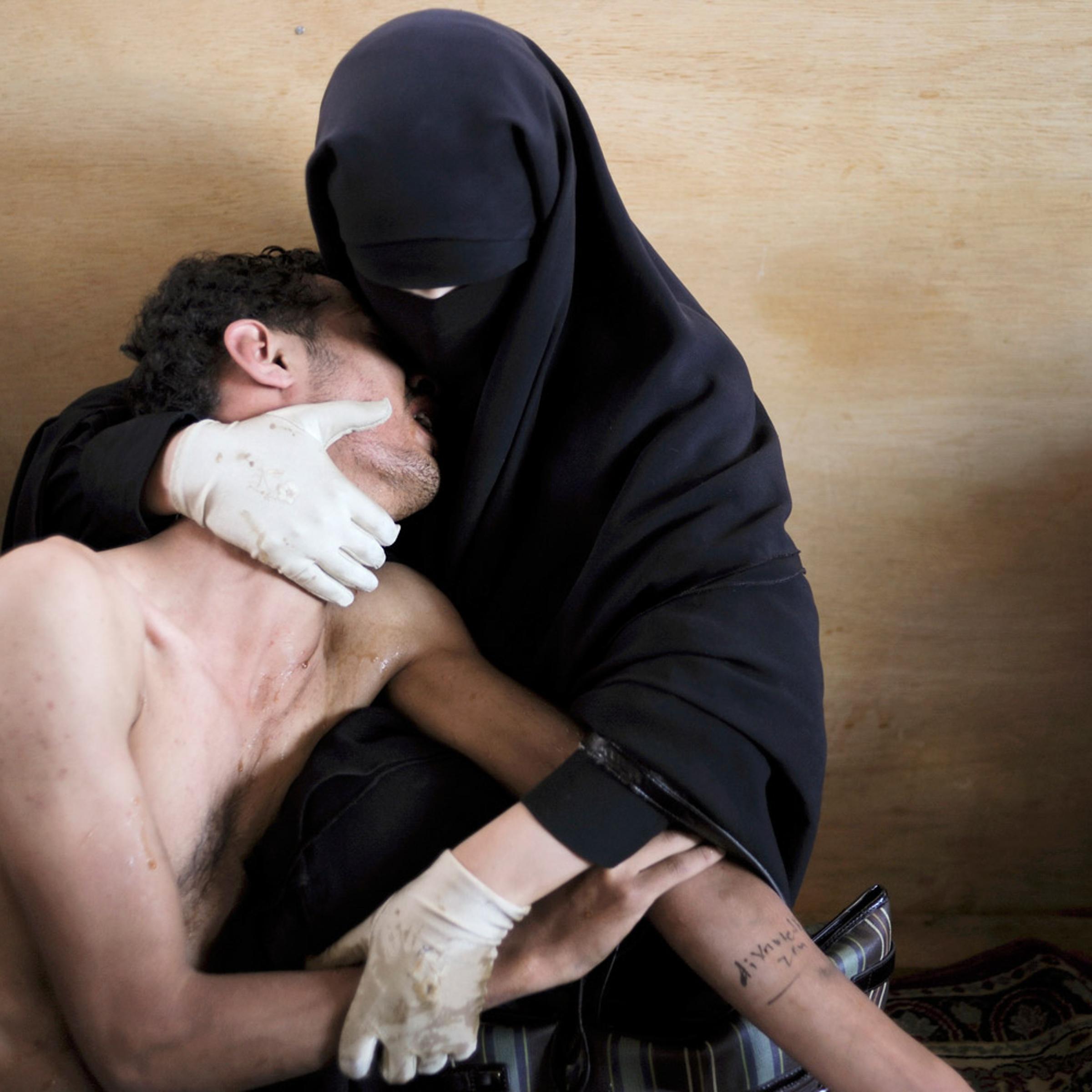 World Press Photo of the Year 2011<br><br>A woman holds a wounded relative in her arms, inside a mosque used as a field hospital by demonstrators against the rule of President Ali Abdullah Saleh, during clashes in Sanaa, Yemen on October 15, 2011.
