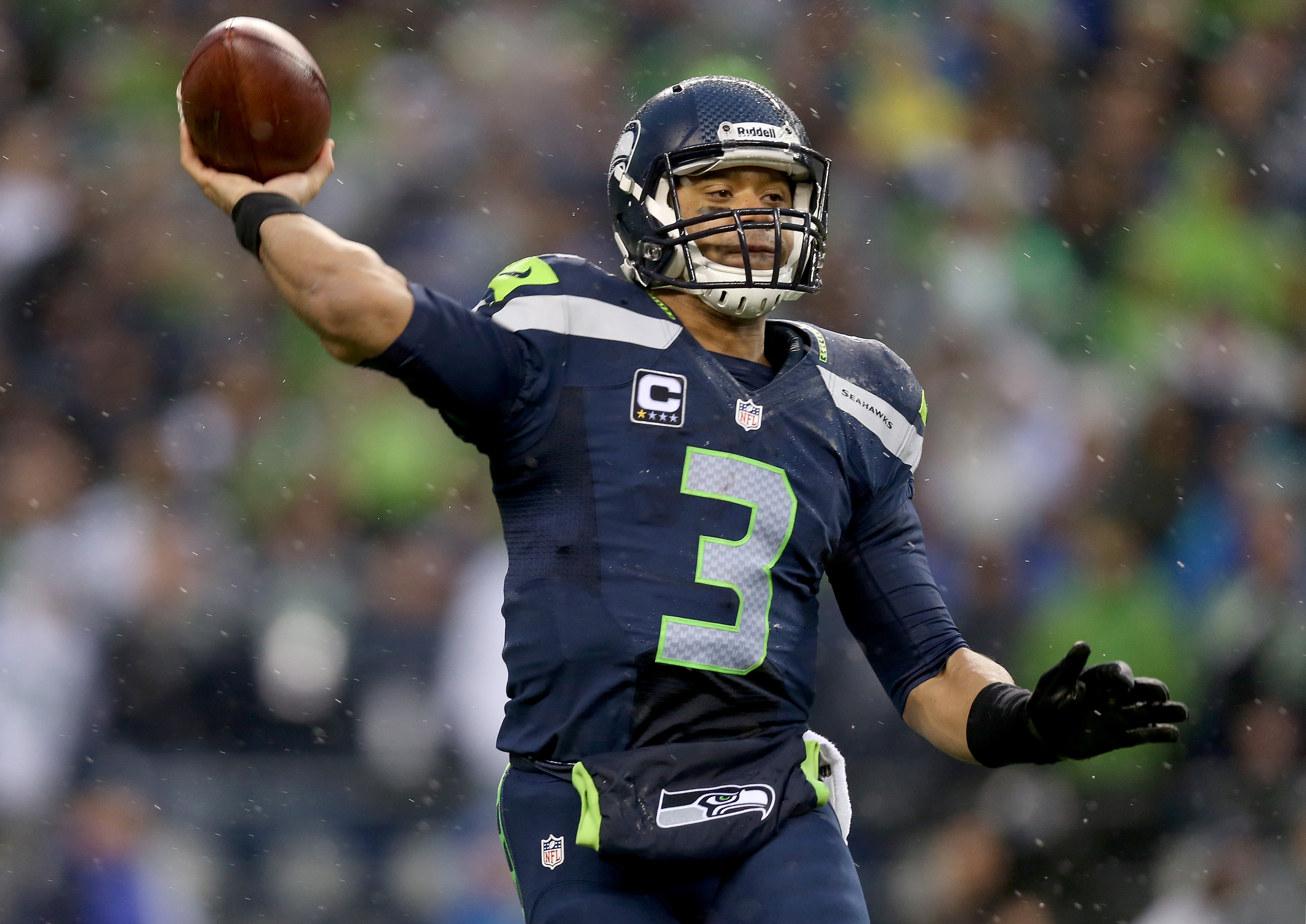 Quarterback Russell Wilson of the Seattle Seahawks throws the ball in the second half while taking on the New Orleans Saints during the NFC Divisional Playoff Game at CenturyLink Field on January 11, 2014 in Seattle.