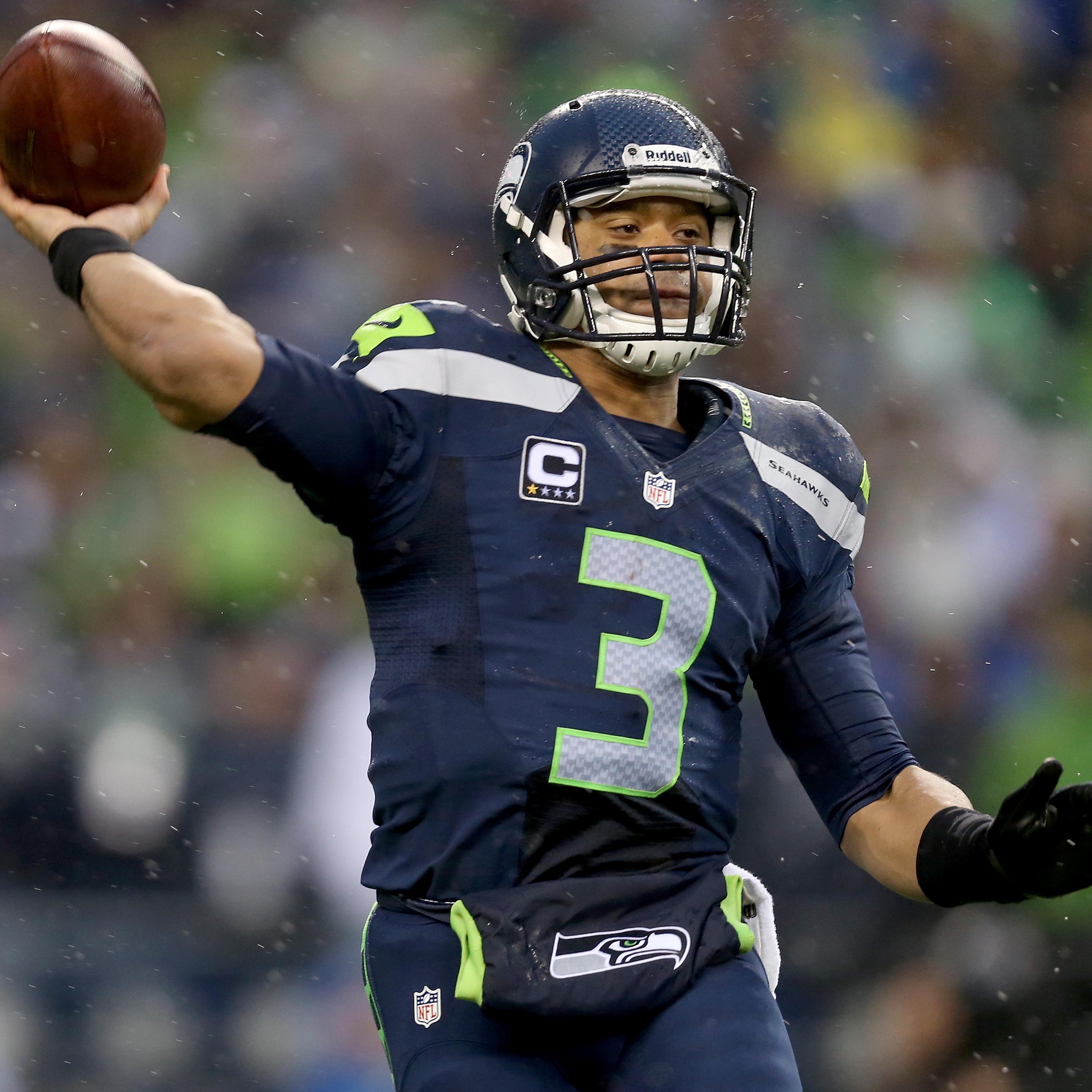 Quarterback Russell Wilson of the Seattle Seahawks throws the ball in the second half while taking on the New Orleans Saints during the NFC Divisional Playoff Game at CenturyLink Field on January 11, 2014 in Seattle.