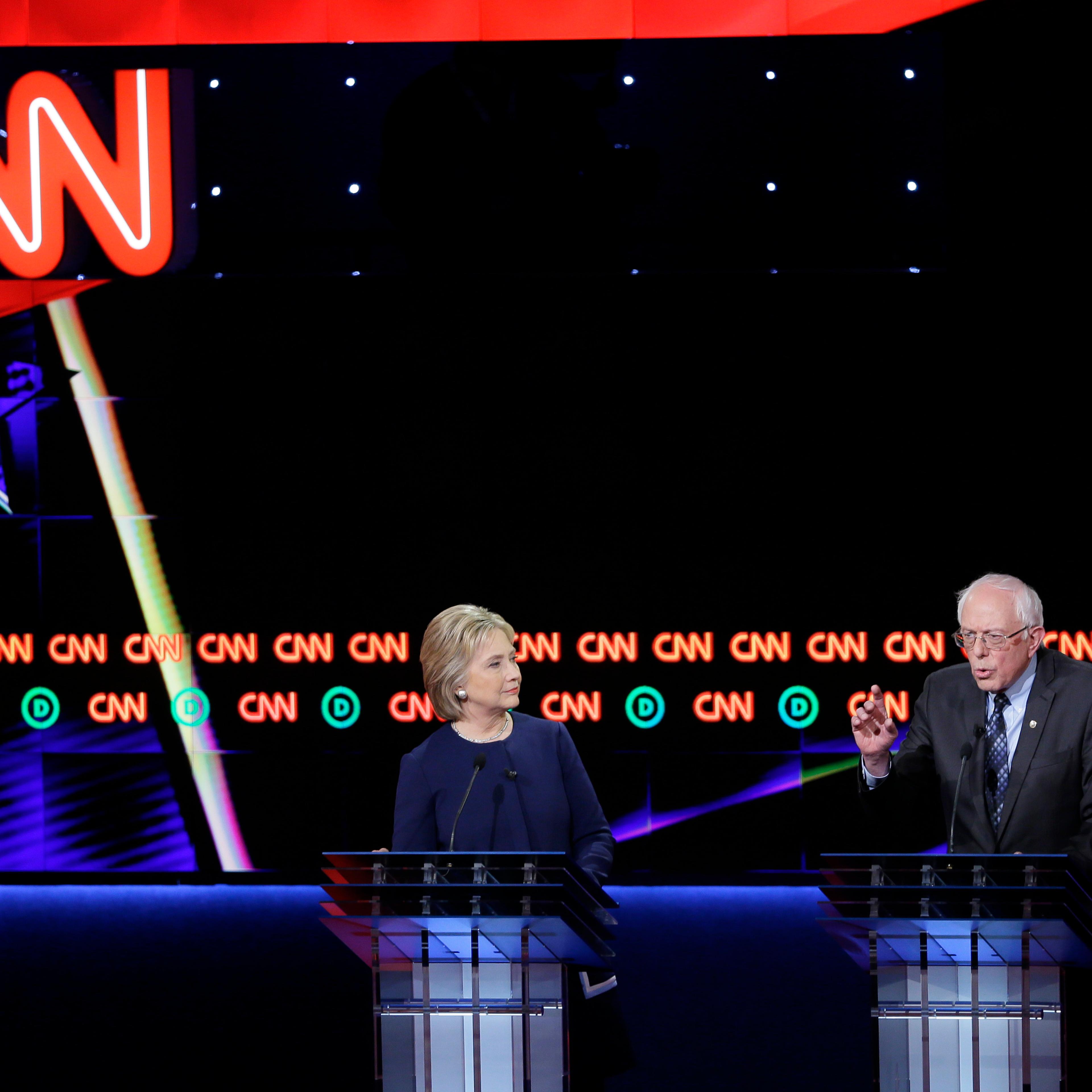 Democratic presidential candidate, Sen. Bernie Sanders argues a point as Hillary Clinton listens during a Democratic presidential primary debate at the University of Michigan-Flint in Flint, Mich. on March 6, 2016, in Flint, Mich.