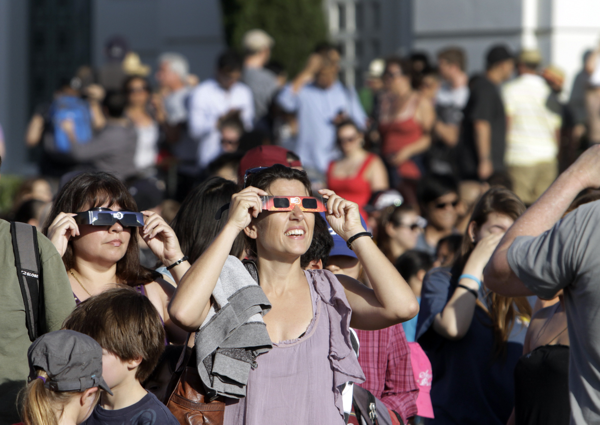 Visitors at the park. Griffith observatory in Los Angeles holds a public viewing of the partial sol