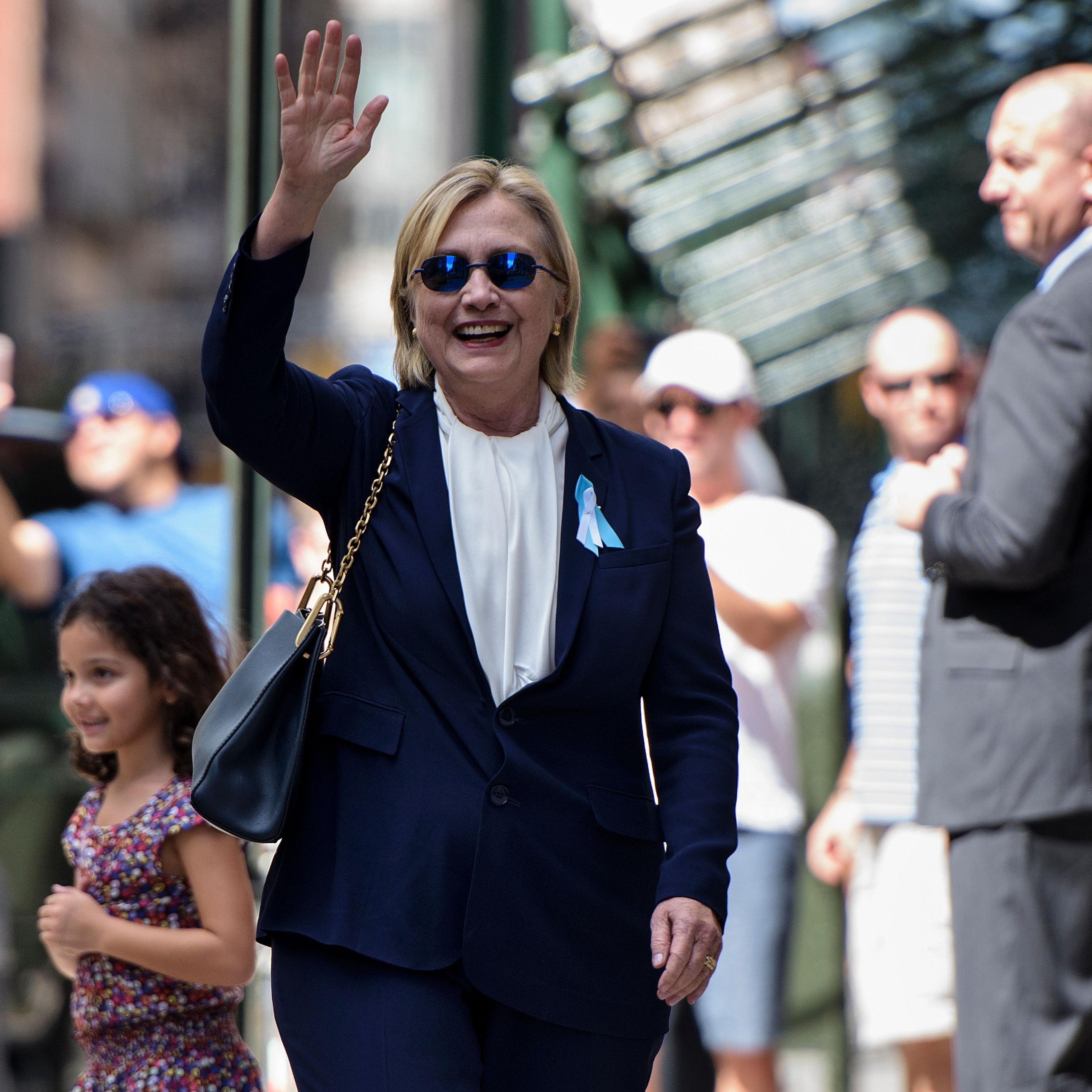 Democratic presidential nominee Hillary Clinton waves to the press as she leaves her daughter's apartment building after resting in New York on on Sept. 11, 2016.