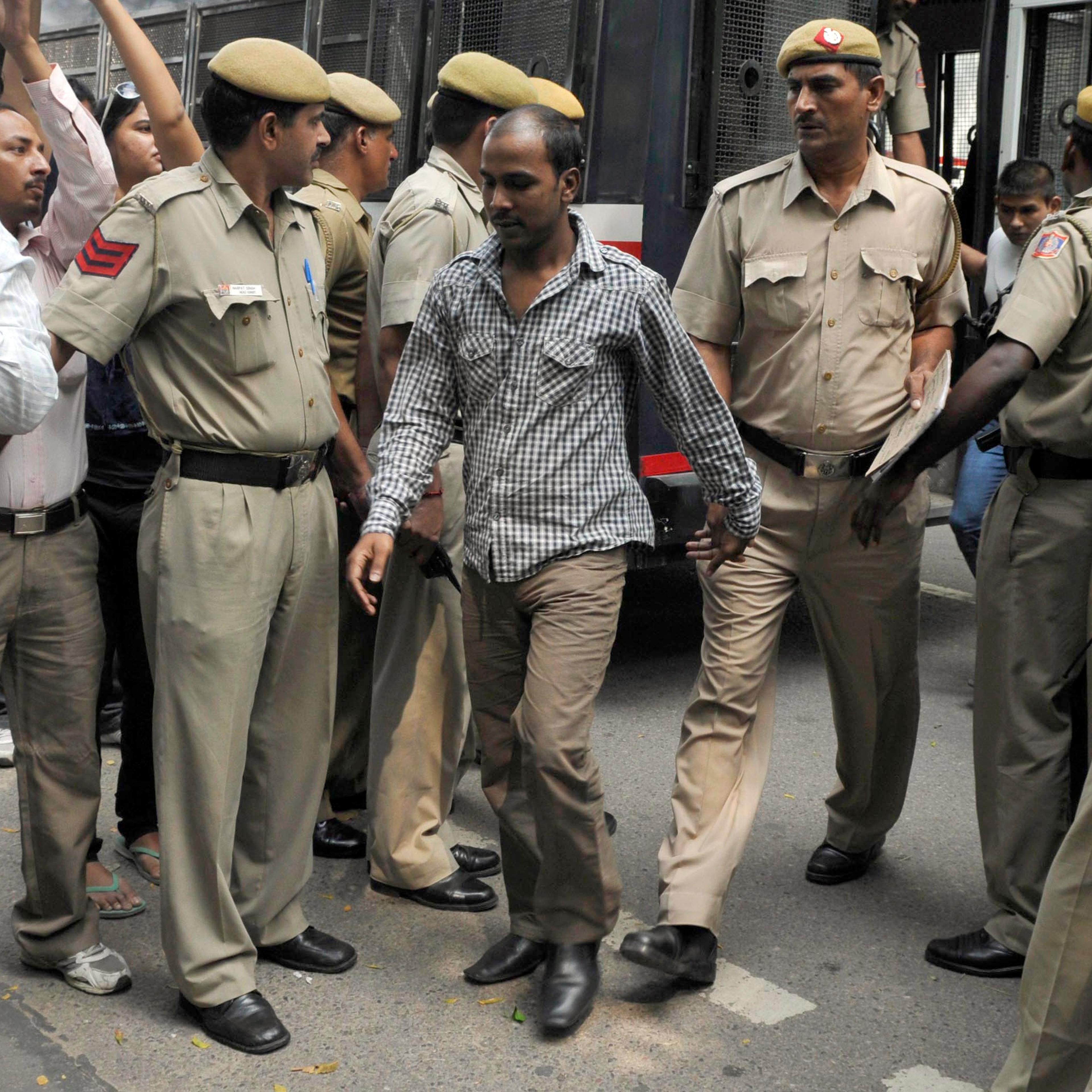 Mukesh Singh, one of the four men who were sentenced to death for the rape and murder of a young woman on a bus last December, is escorted by police outside a court in New Delhi