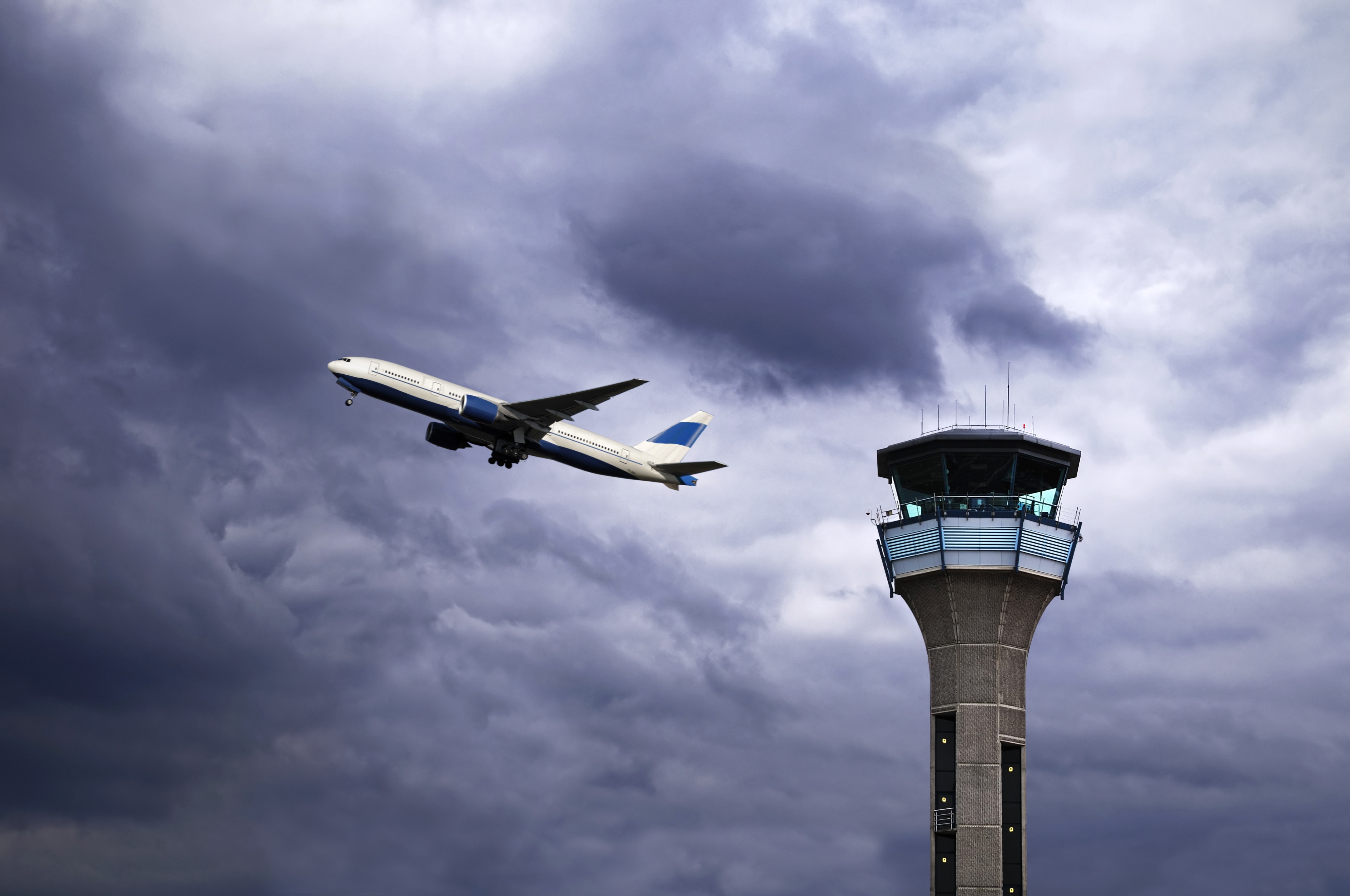 UK, Luton Airport, Air Traffic Control Tower with Plane Taking Off