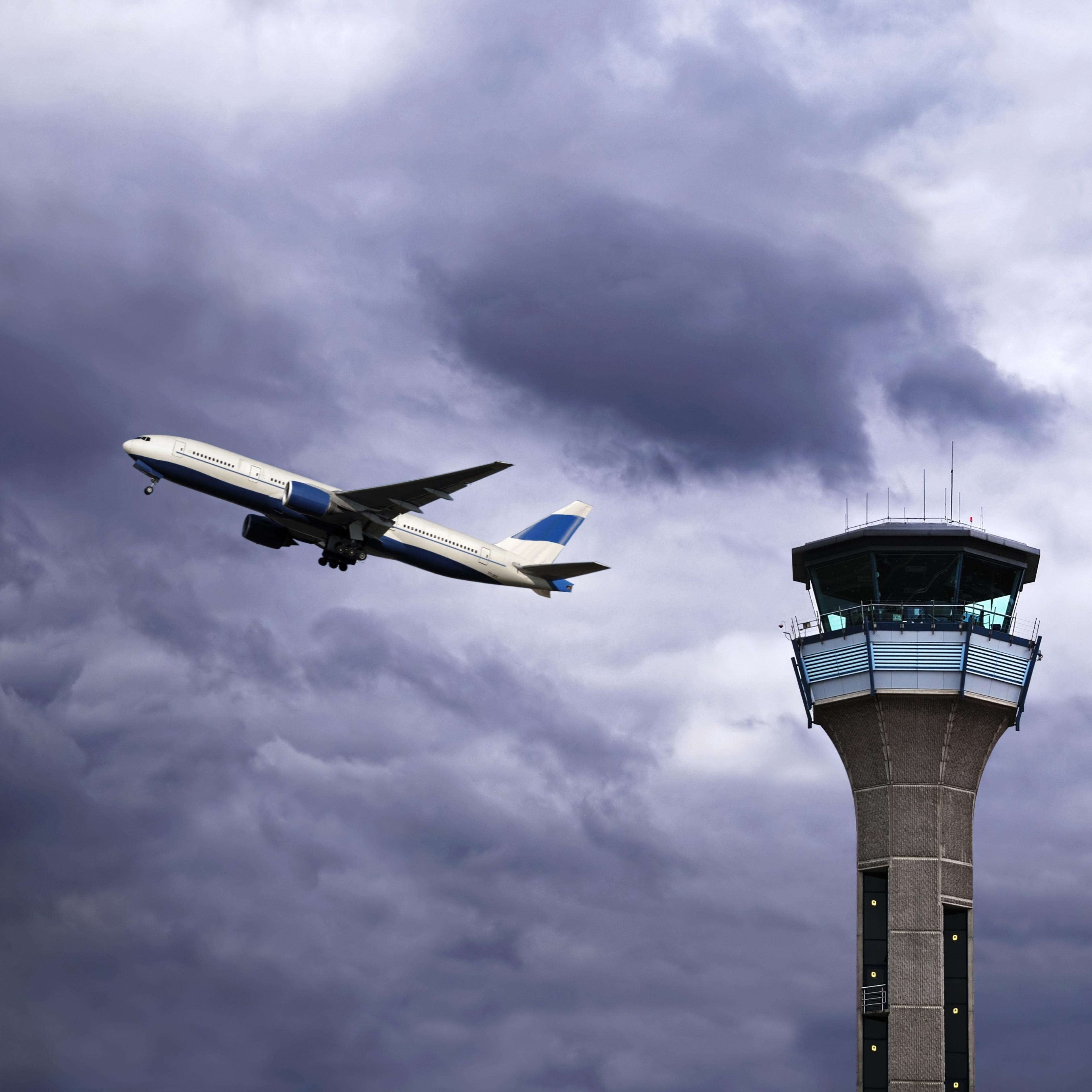 UK, Luton Airport, Air Traffic Control Tower with Plane Taking Off