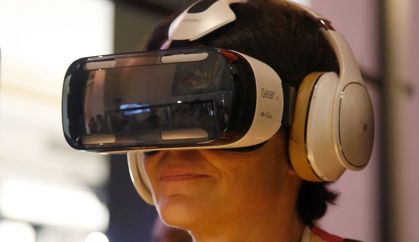 An attendee tries an Oculus-powered Samsung Gear VR headset during the French telecom Orange annual company's innovations show in Paris