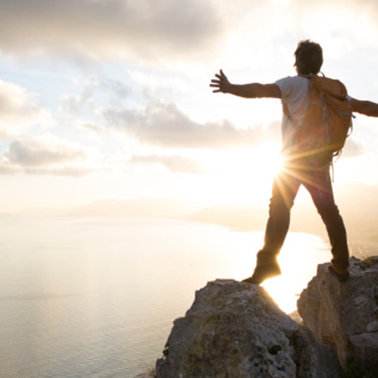 man-standing-mountain-top