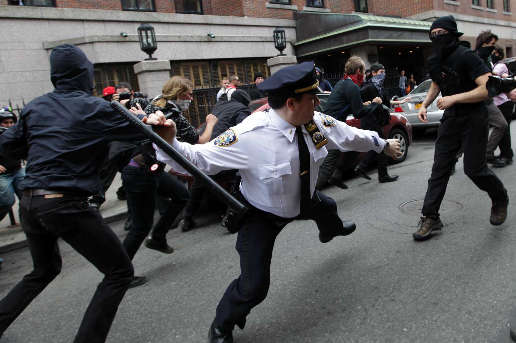 A police lieutenant swings his baton at Occupy Wall Street activists in New York City on May 1, 2012.