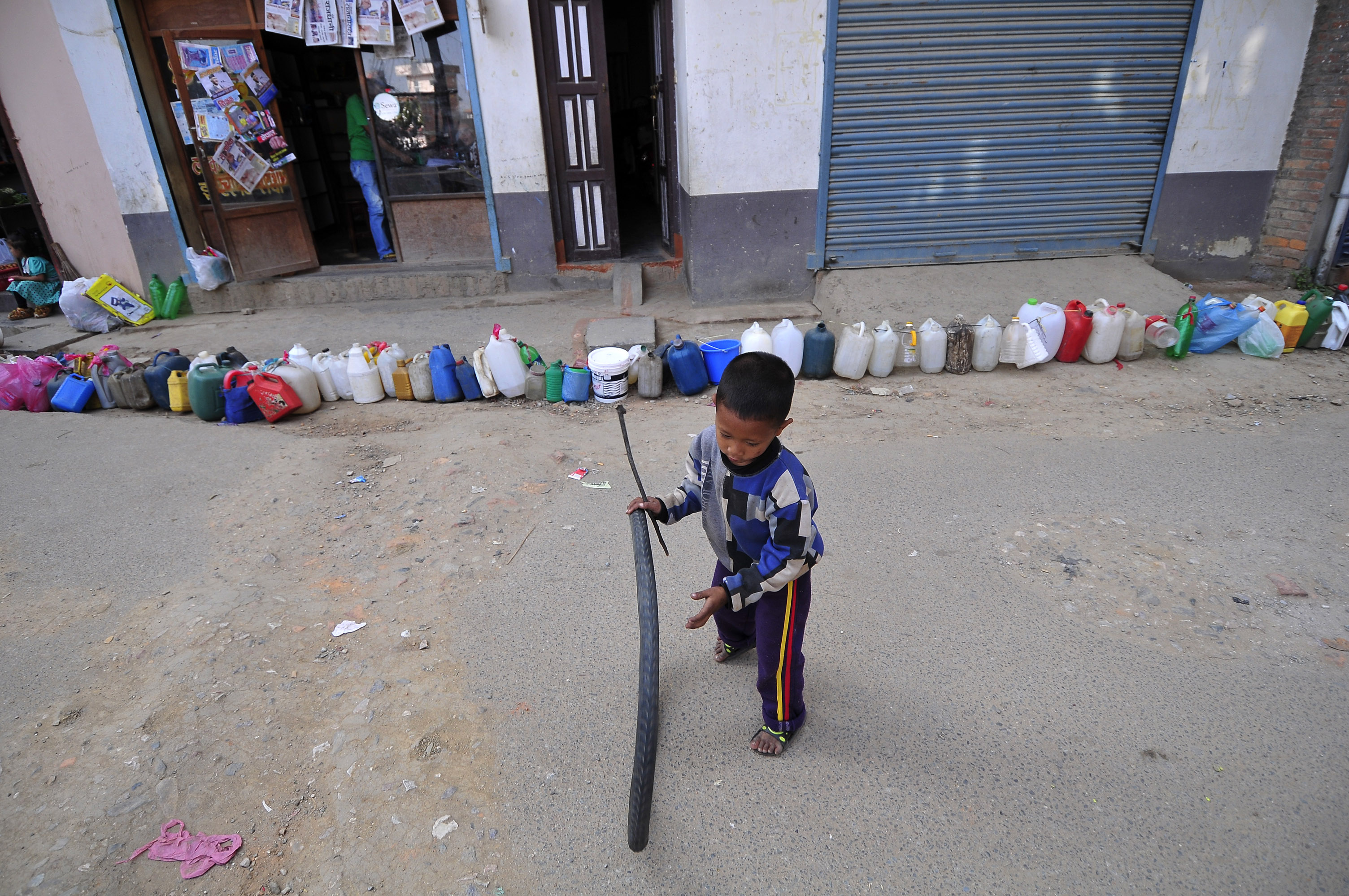 A Nepalese kid plays while waiting for his parents' time to