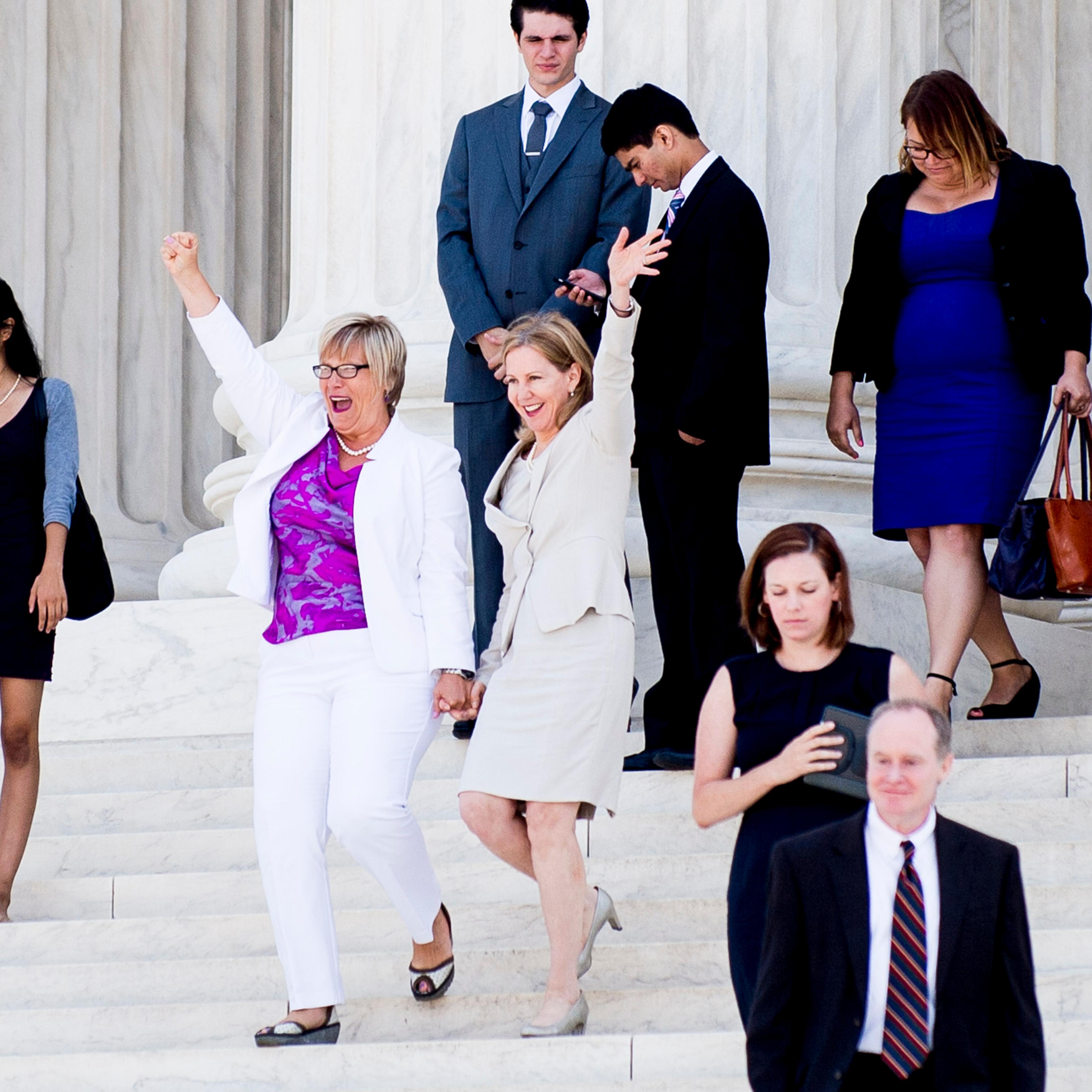 Texas abortion provider Amy Hagstrom-Miller and Nancy Northup, President of The Center for Reproductive Rights wave to supporters as they descend the steps of the United States Supreme Court in Washington, D.C., on June 27, 2016.