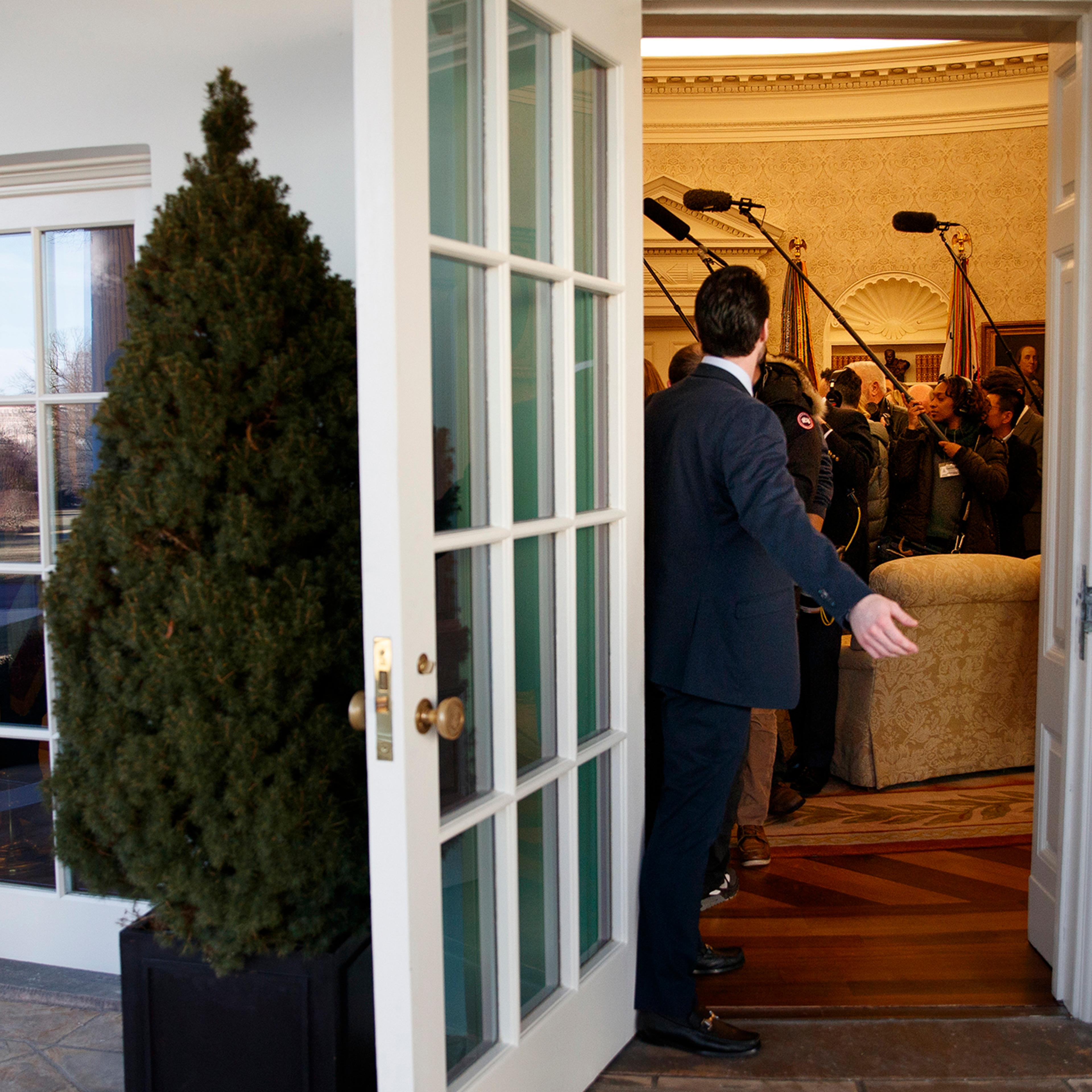 Members of the press in the Oval Office