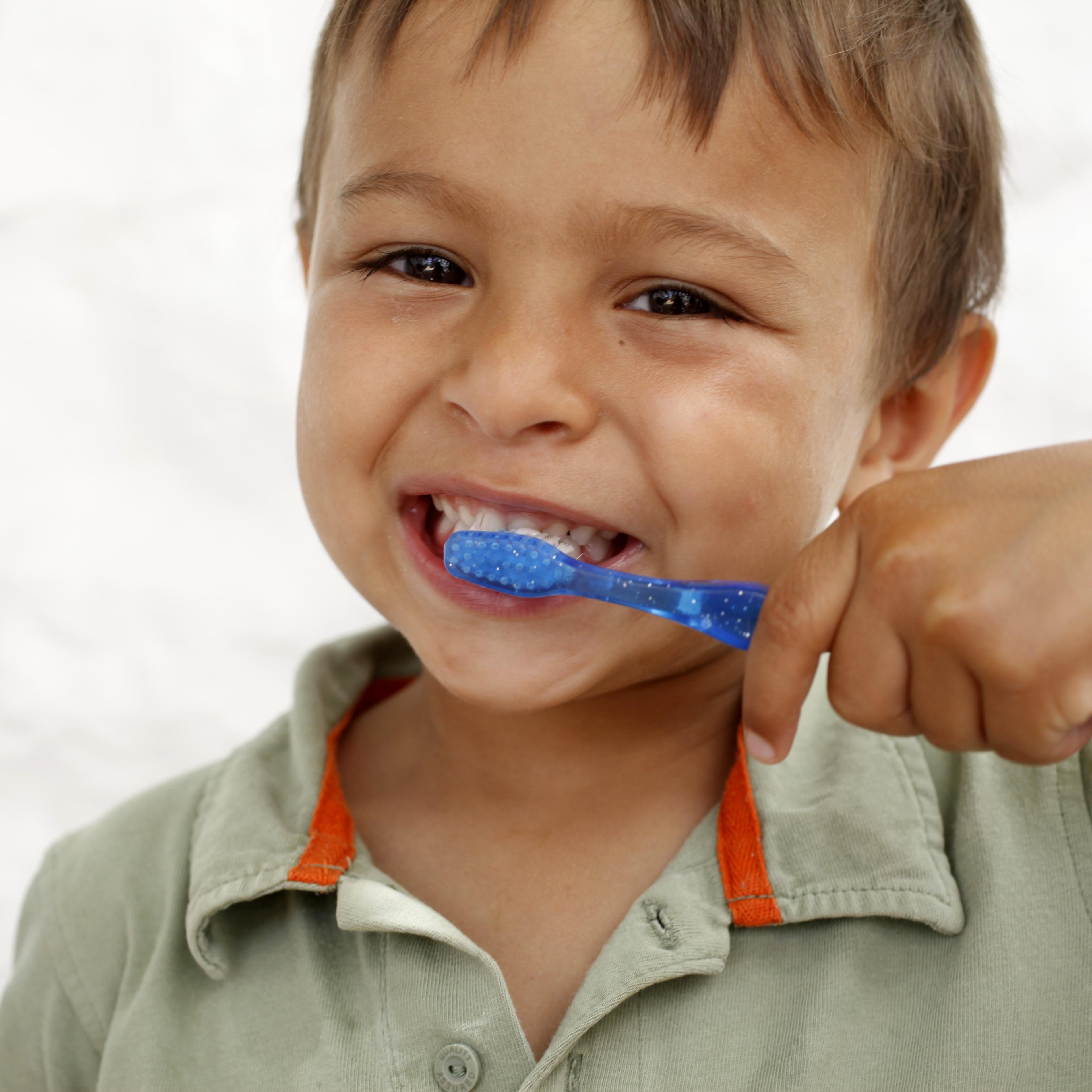 Young boy brushing teeth, Italy