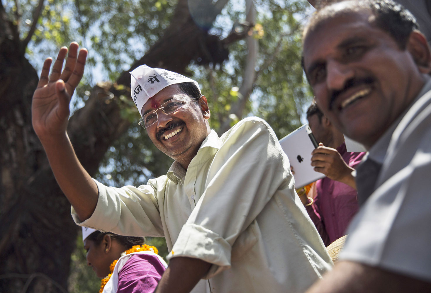 Leader of the AAP and anti-corruption activist Arvind Kejriwal waves to supporters while campaigning on April 8, 2014 in New Delhi.