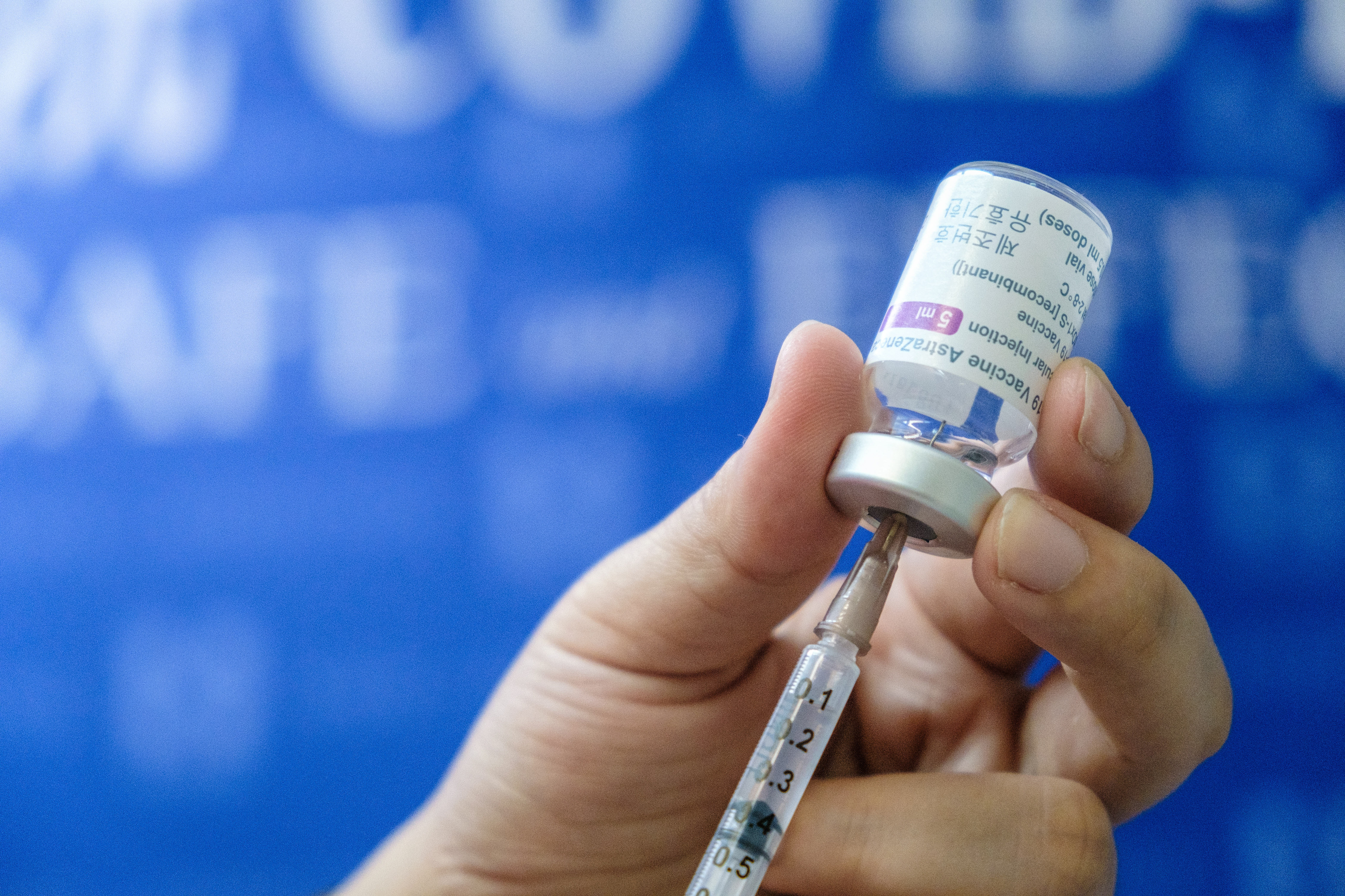 A medical workers prepares a dose of AstraZeneca vaccine