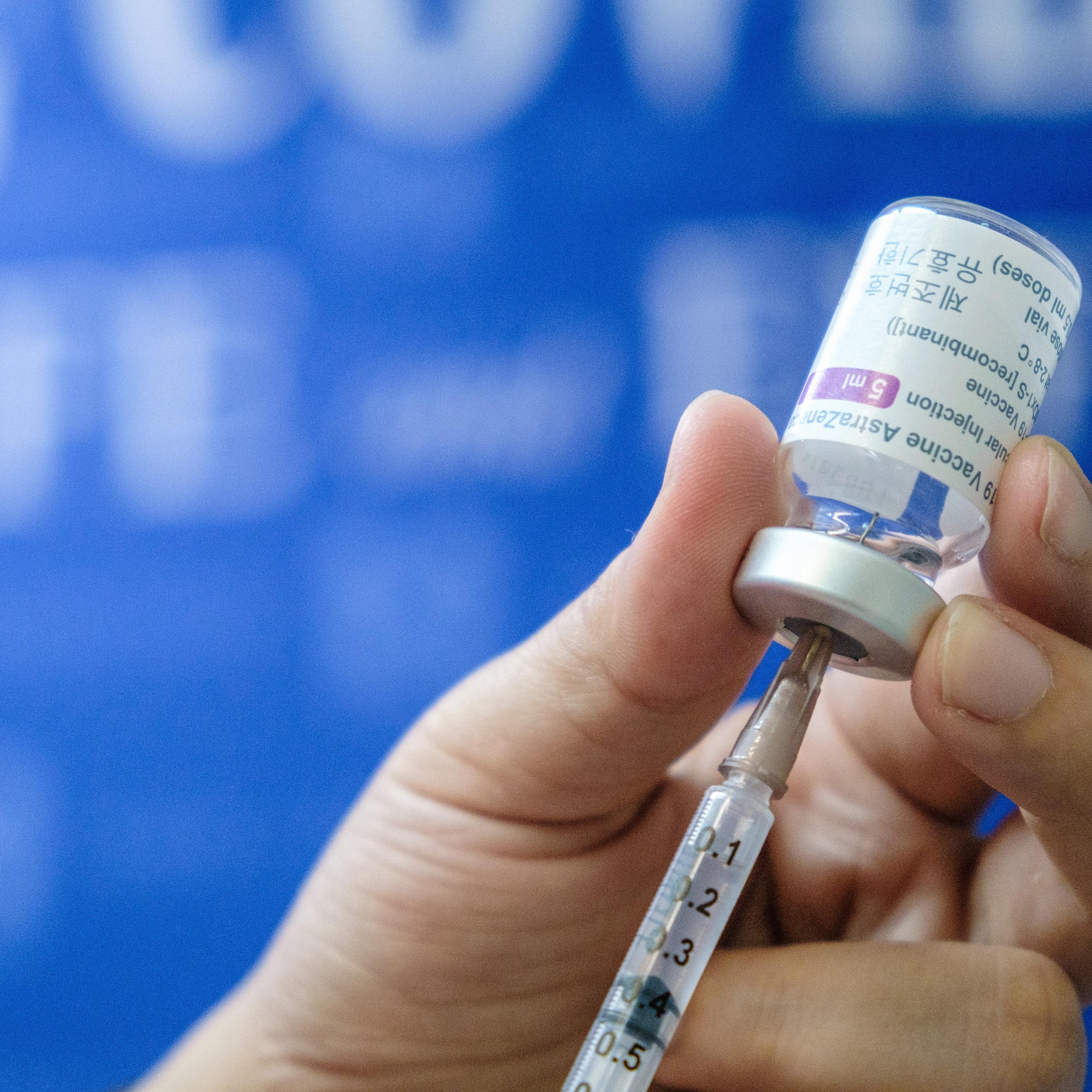 A medical workers prepares a dose of AstraZeneca vaccine