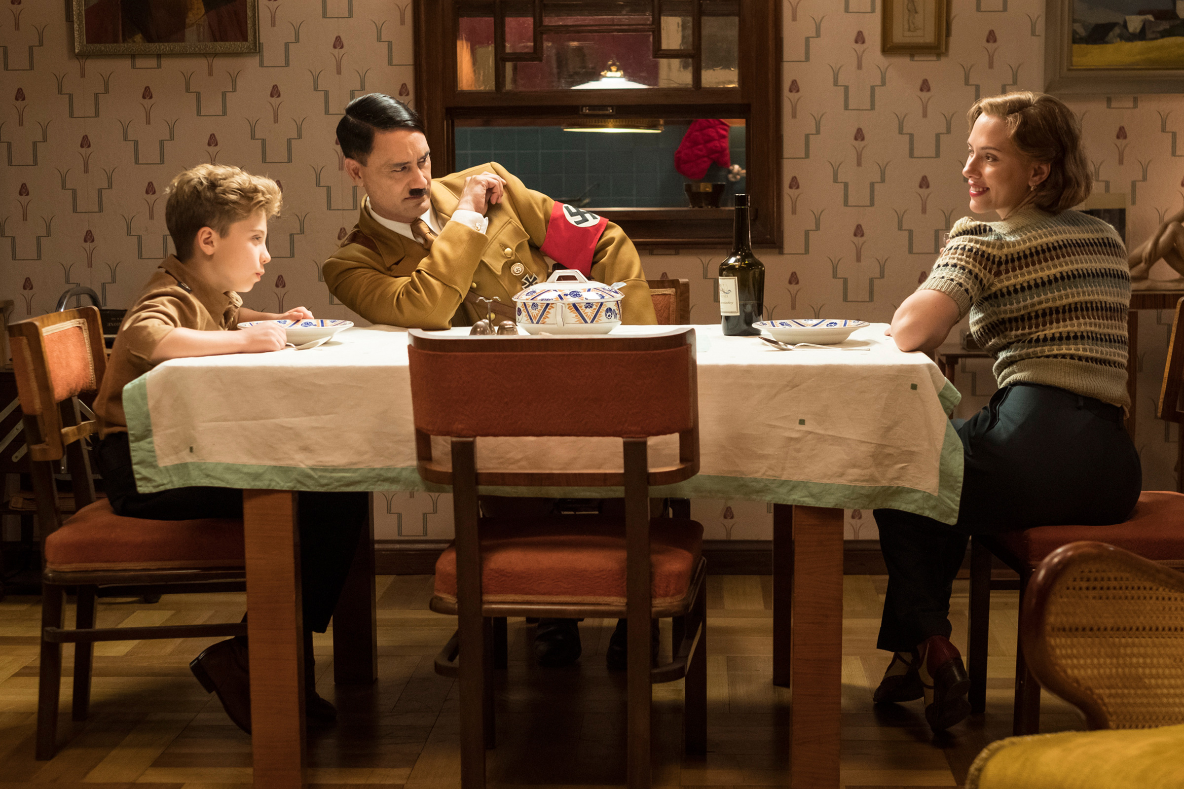 Davis, Waititi and Johansson in Jojo Rabbit: good battles evil at the family dinner table
