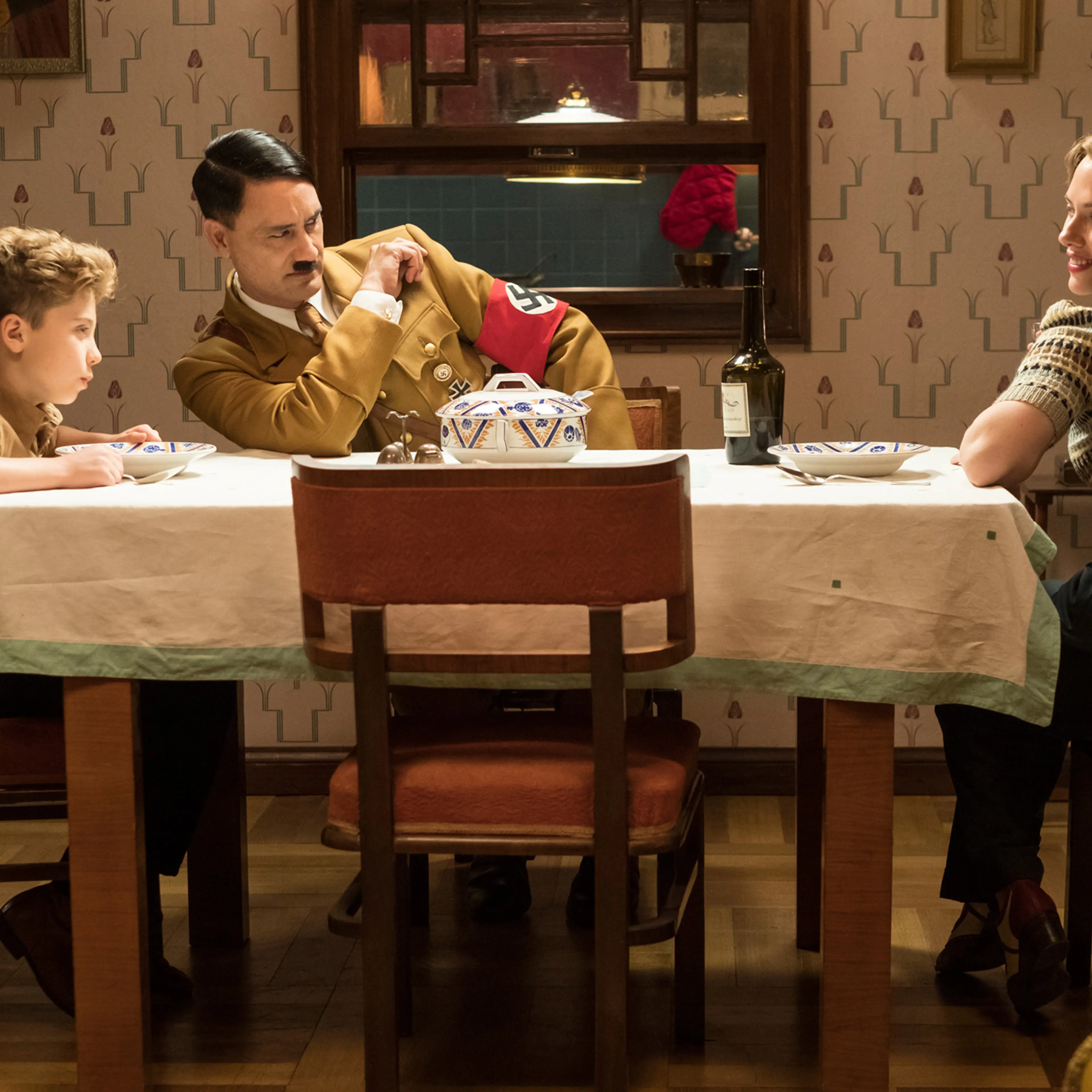 Davis, Waititi and Johansson in Jojo Rabbit: good battles evil at the family dinner table