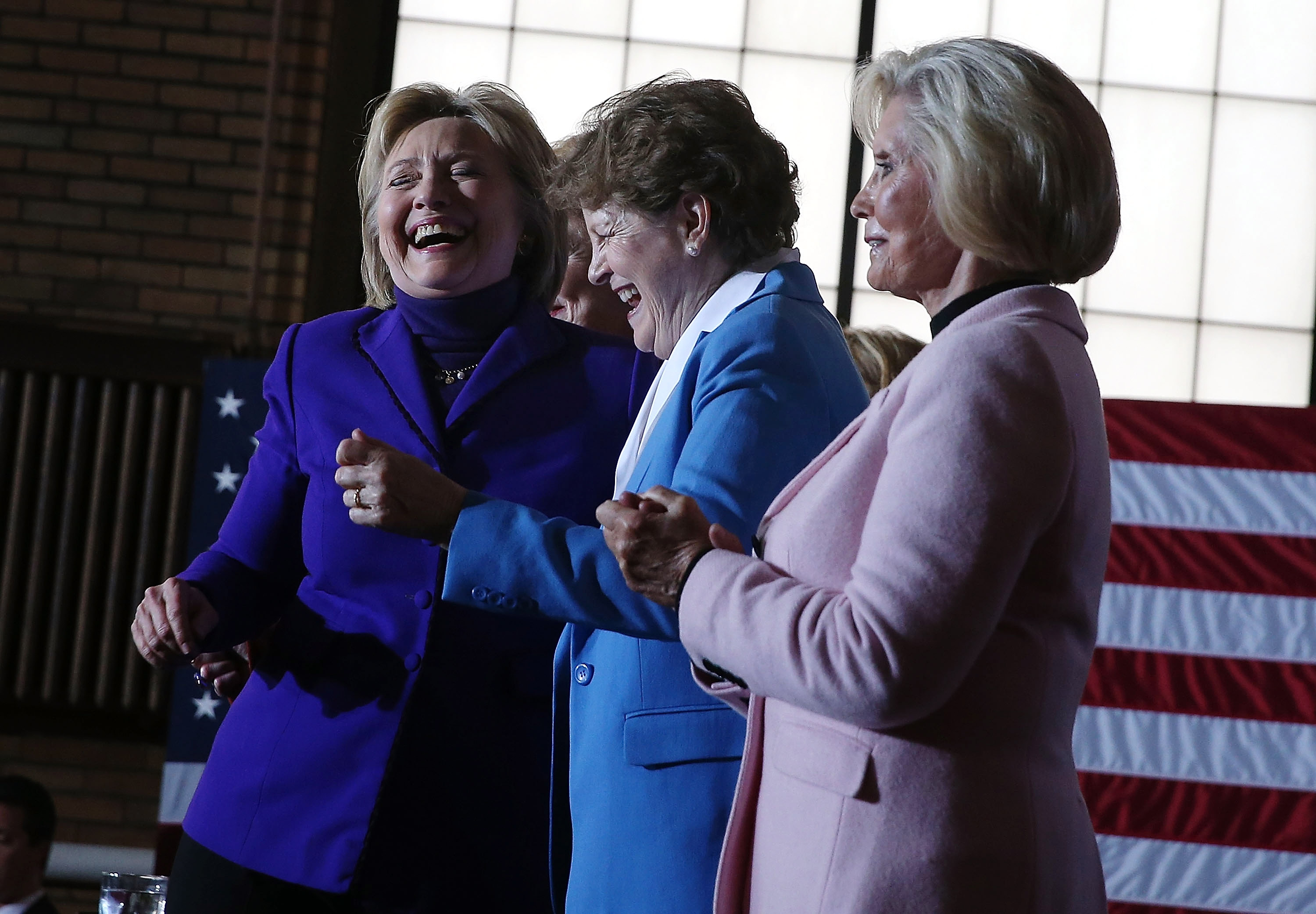 MANCHESTER, NH - FEBRUARY 05: (L-R) Democratic presidential candidate former Secretary of State Hillary Clinton dances with U.S. Sen. Jeanne Shaheen (D-NH) and Lilly Ledbetter during a canvas kickoff event at the YWCA of Manchester on February 5, 2016 in
