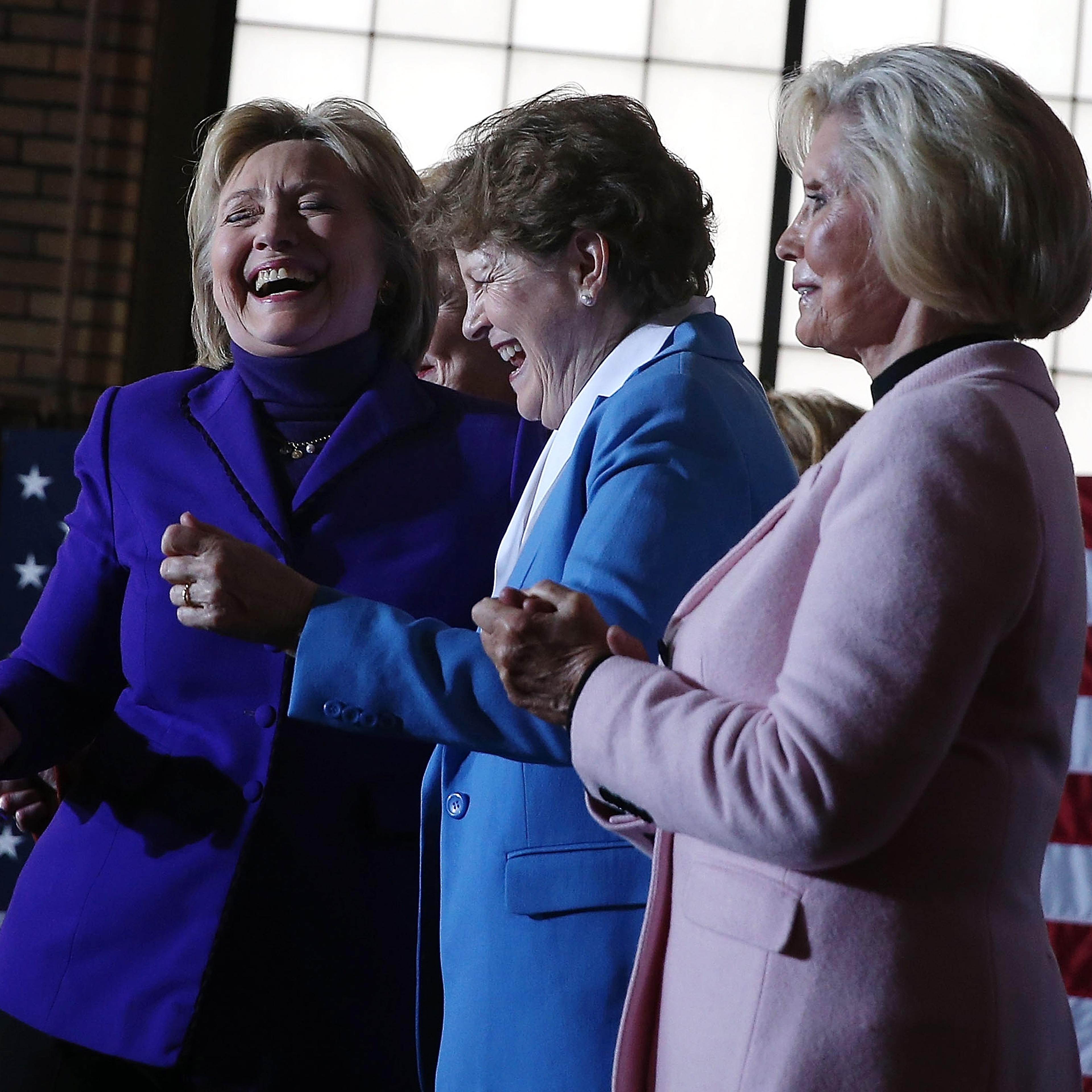 MANCHESTER, NH - FEBRUARY 05: (L-R) Democratic presidential candidate former Secretary of State Hillary Clinton dances with U.S. Sen. Jeanne Shaheen (D-NH) and Lilly Ledbetter during a canvas kickoff event at the YWCA of Manchester on February 5, 2016 in