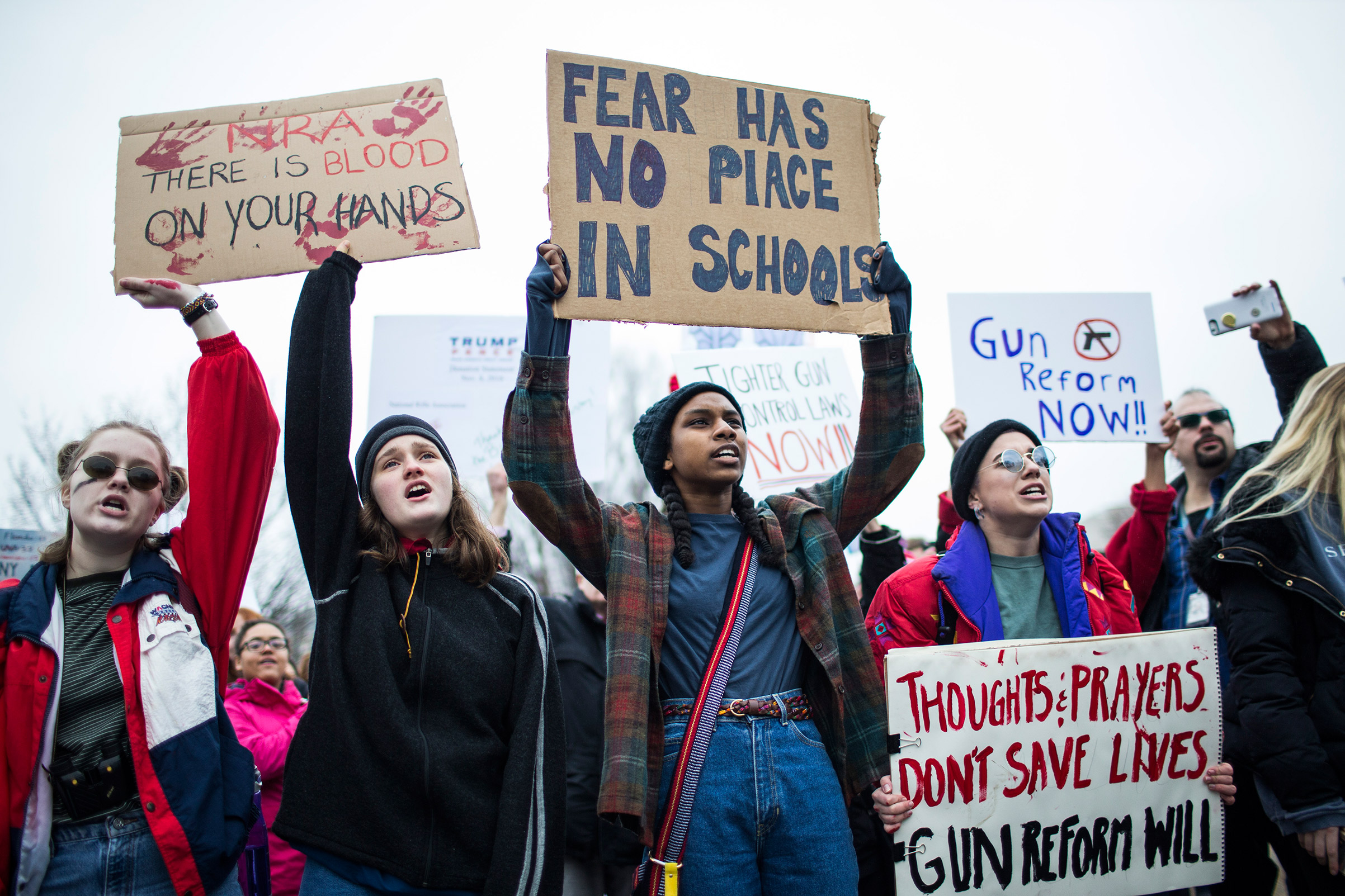 Demonstrators hold signs during a demonstration supporting gun-control reform near the White House on Feb. 19, 2018, in Washington, D.C.