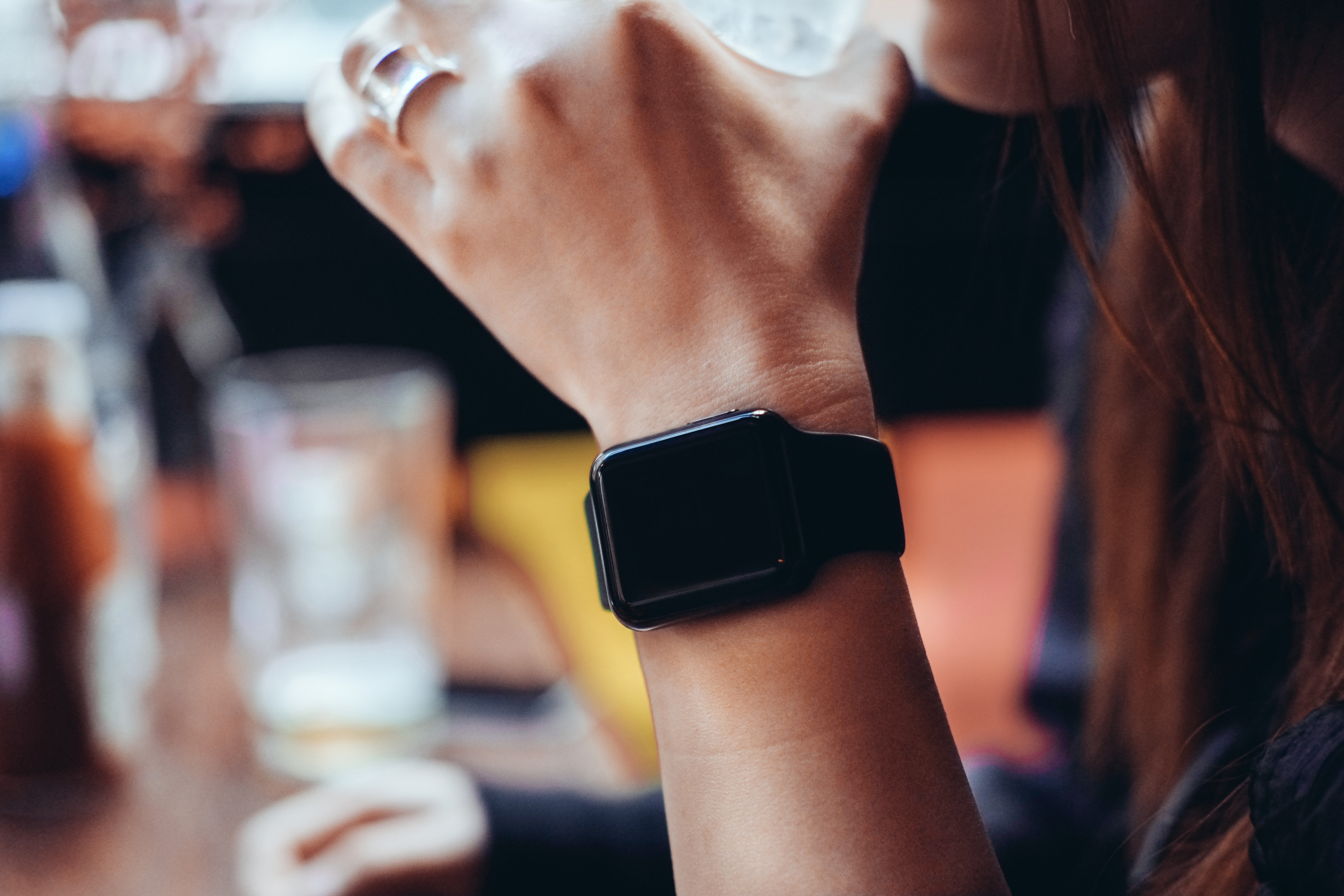 Young woman drinking with smart watch