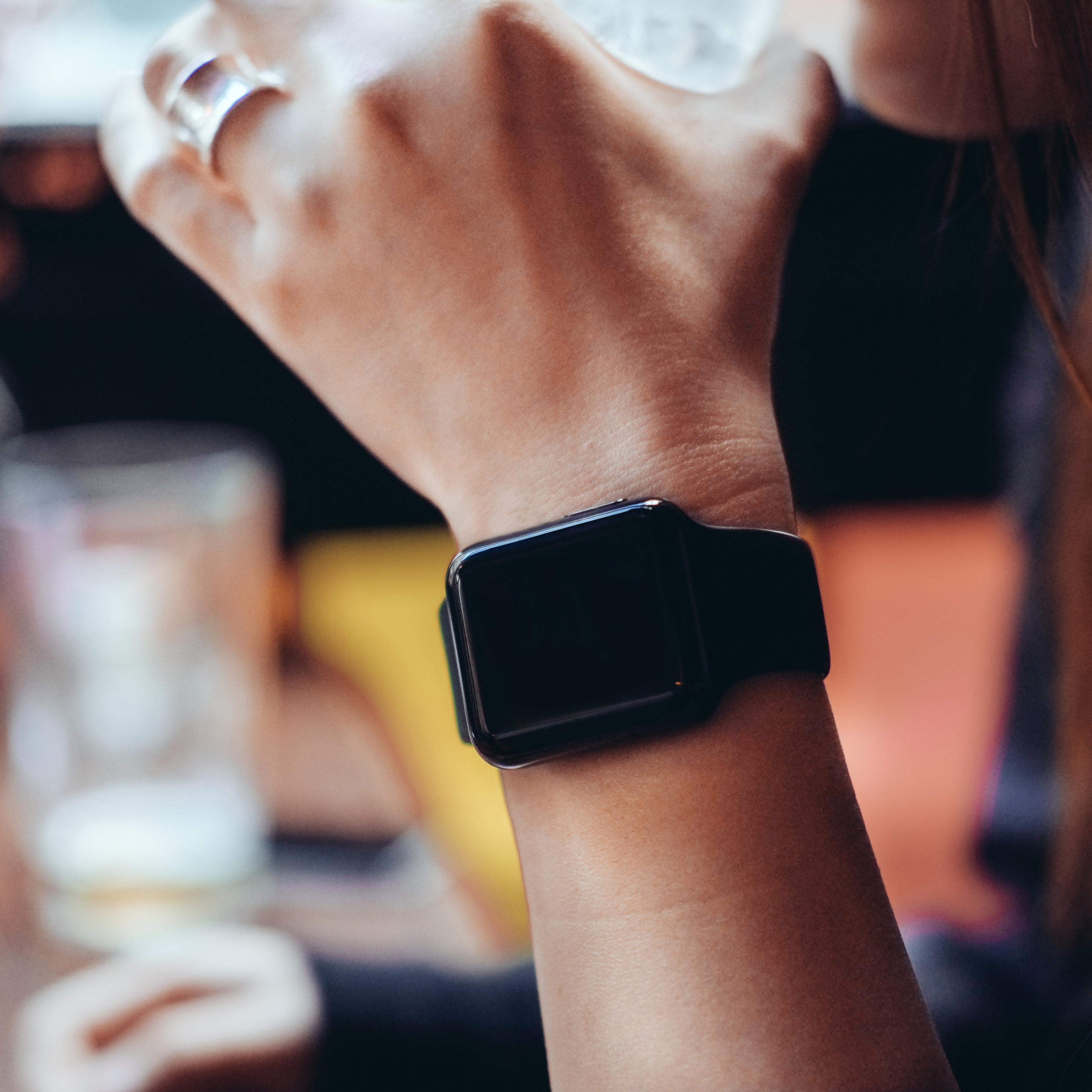 Young woman drinking with smart watch